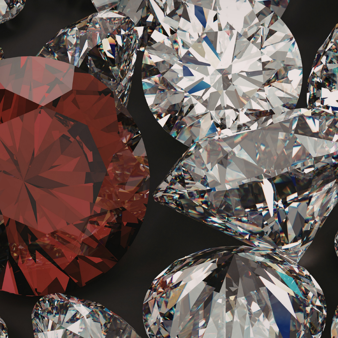 Close-up of multiple sparkling diamonds with different cuts on a dark background.