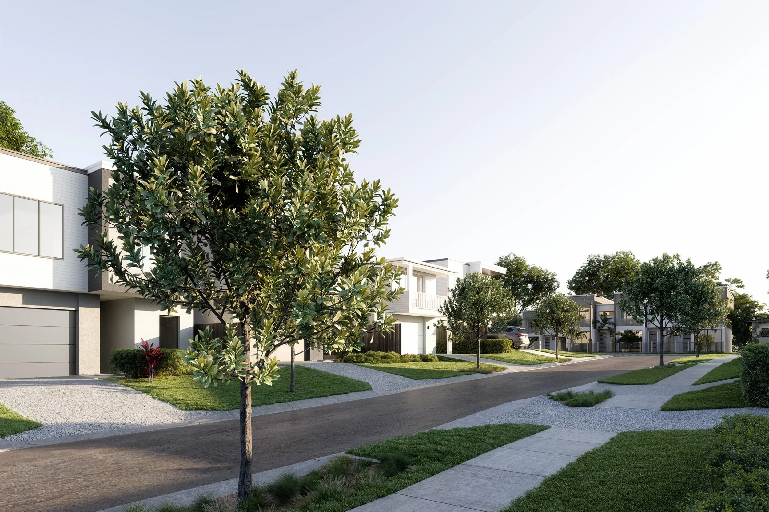 A residential neighborhood with modern townhouses, trees, and a sidewalk.