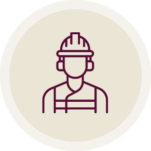 Outline drawing of a person wearing safety gear, including a helmet and overalls.