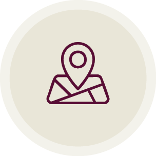 Simple line drawing of a map marker icon on a light beige circular background.