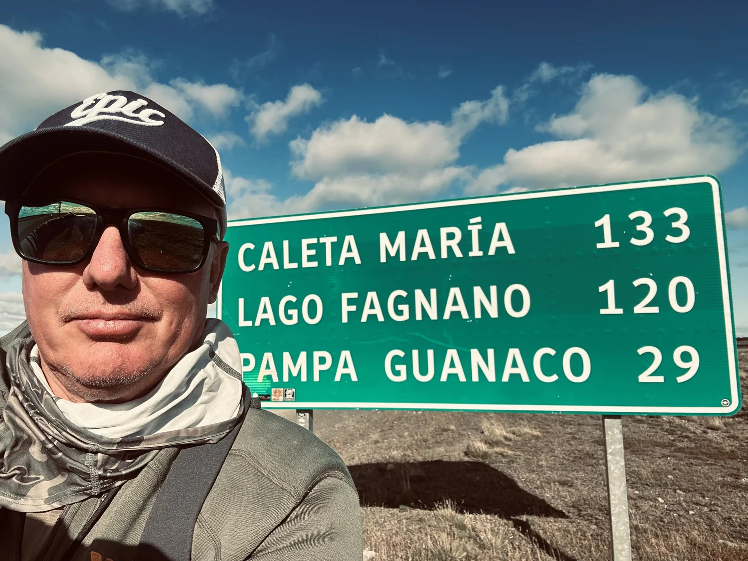 Michael Gregg beside a destination sign in Tierra del Fuego