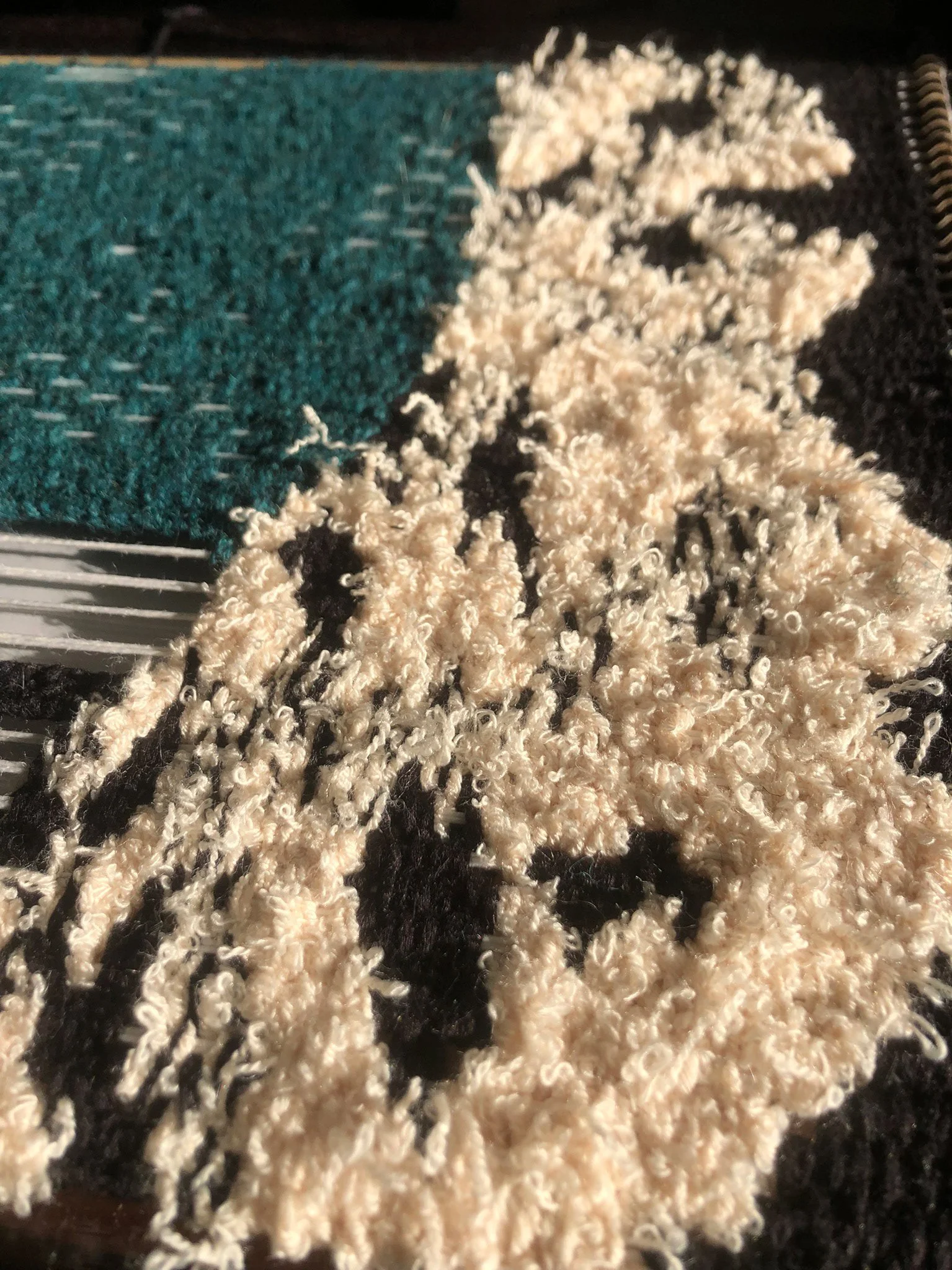 Close-up of a fiber art piece made from a fluffy yarn.
