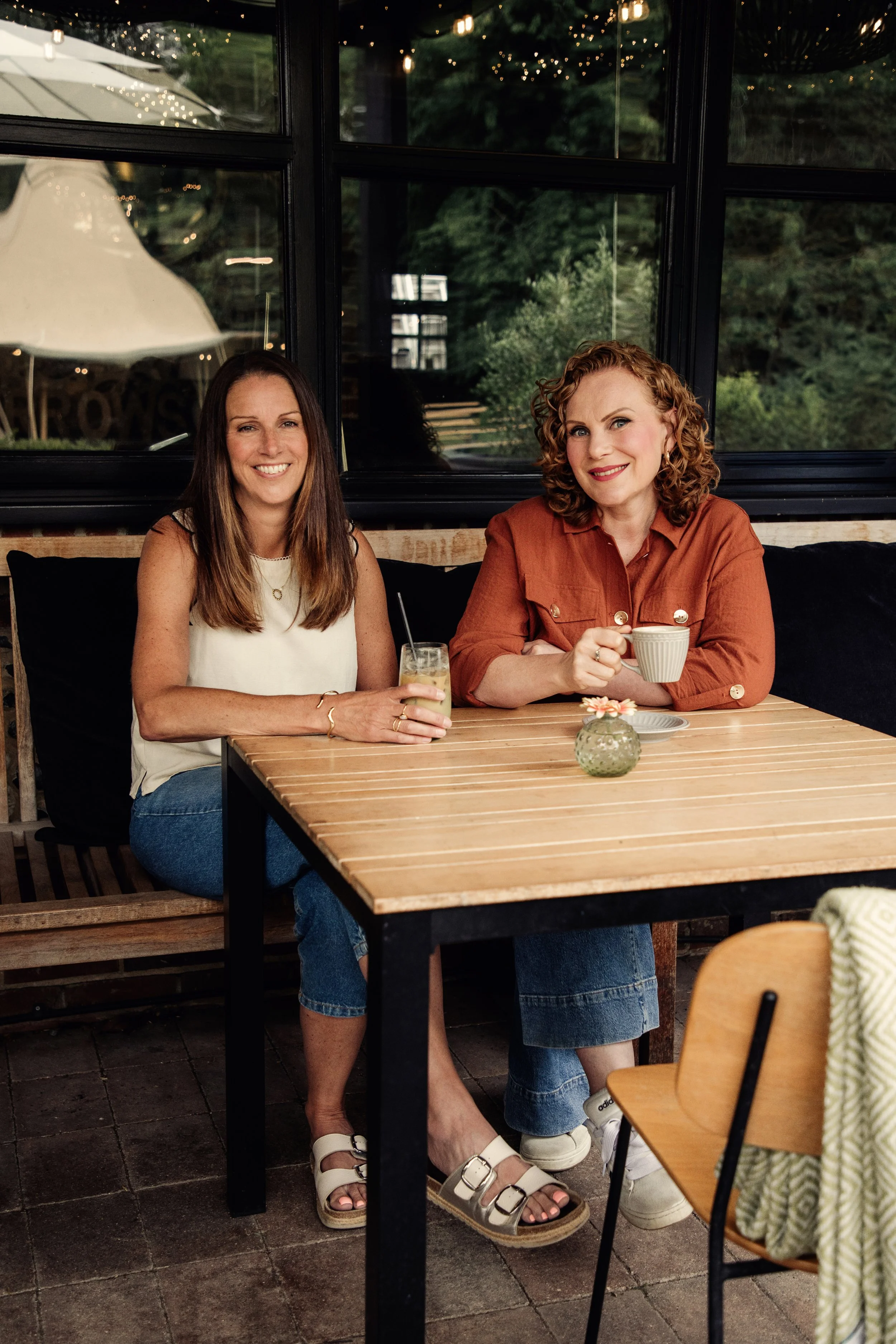 Emma and Caroline from Urbanberry Recruitment, specialist travel recruiters, sitting together in a café.