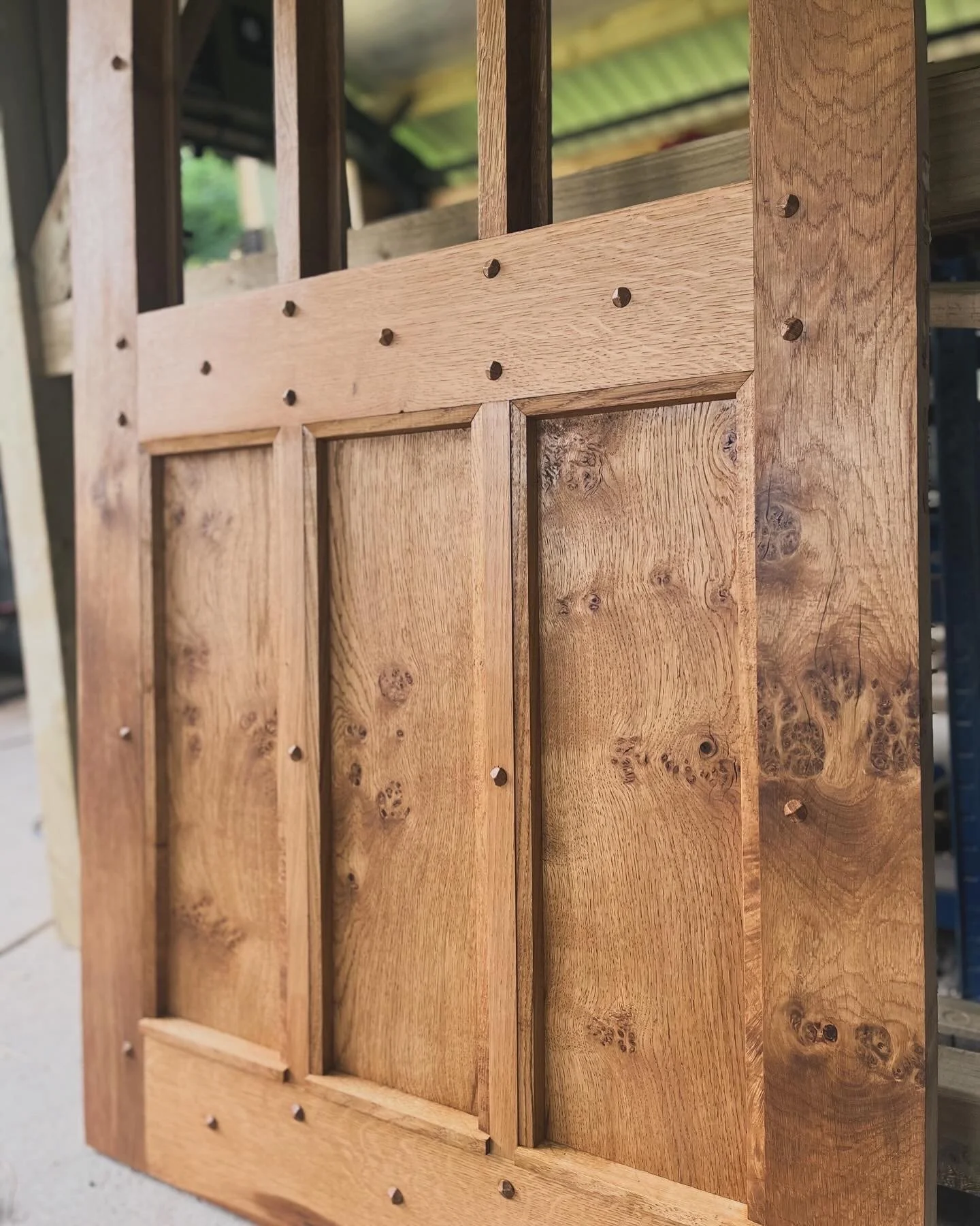 Close-up view of a wooden cabinet or door with decorative panels and visible screws. in Chester 