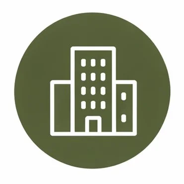 Icon of a cityscape with three buildings in white on a green circular background.