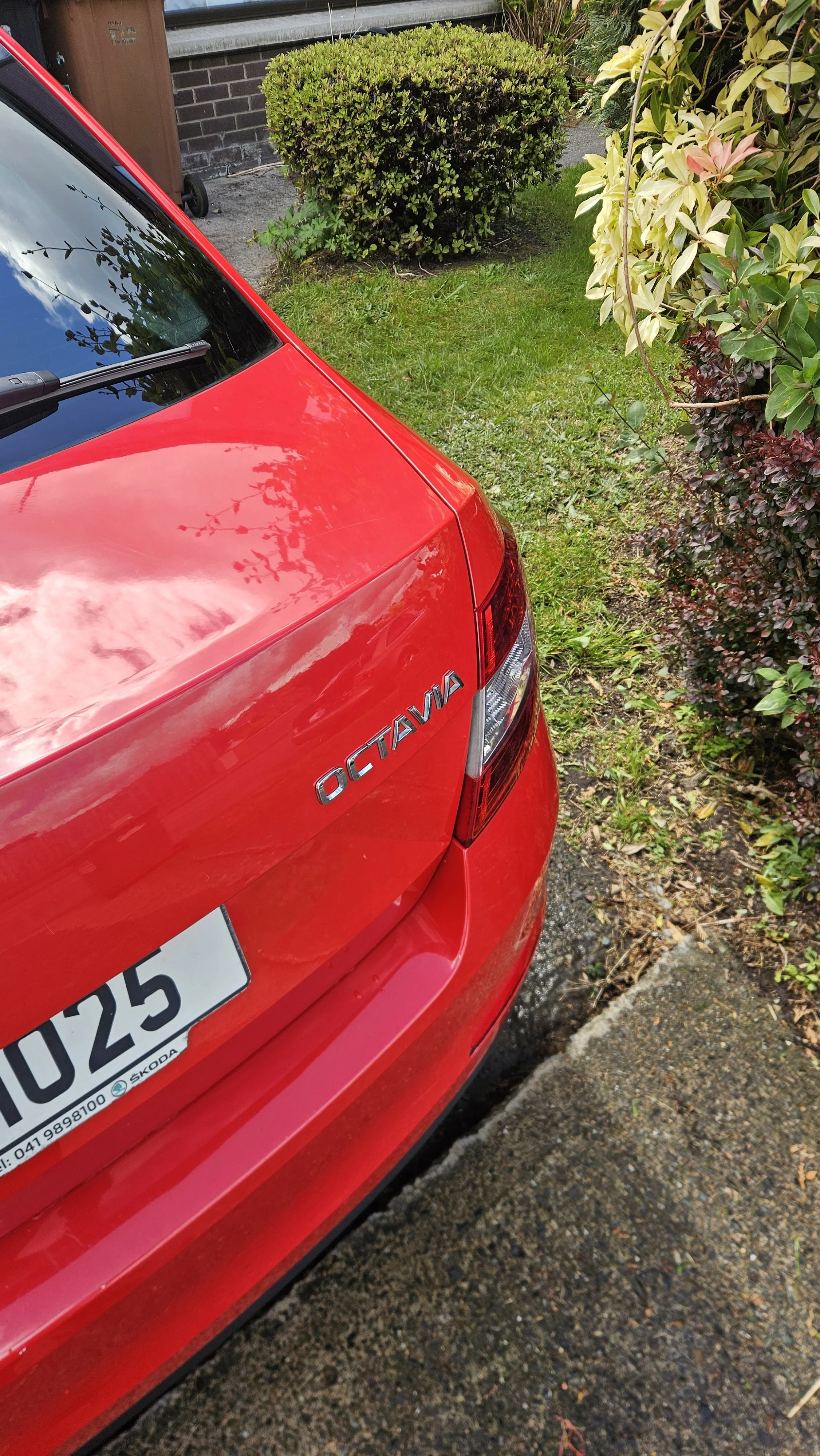 Professional premium exterior full detail and wax and wheel decontamination on a red skoda octavia in Blackrock, Co. Louth, by North East Auto Detailing. The added wax gives the red car a lovely shine and reflection meant to last for 6 weeks.