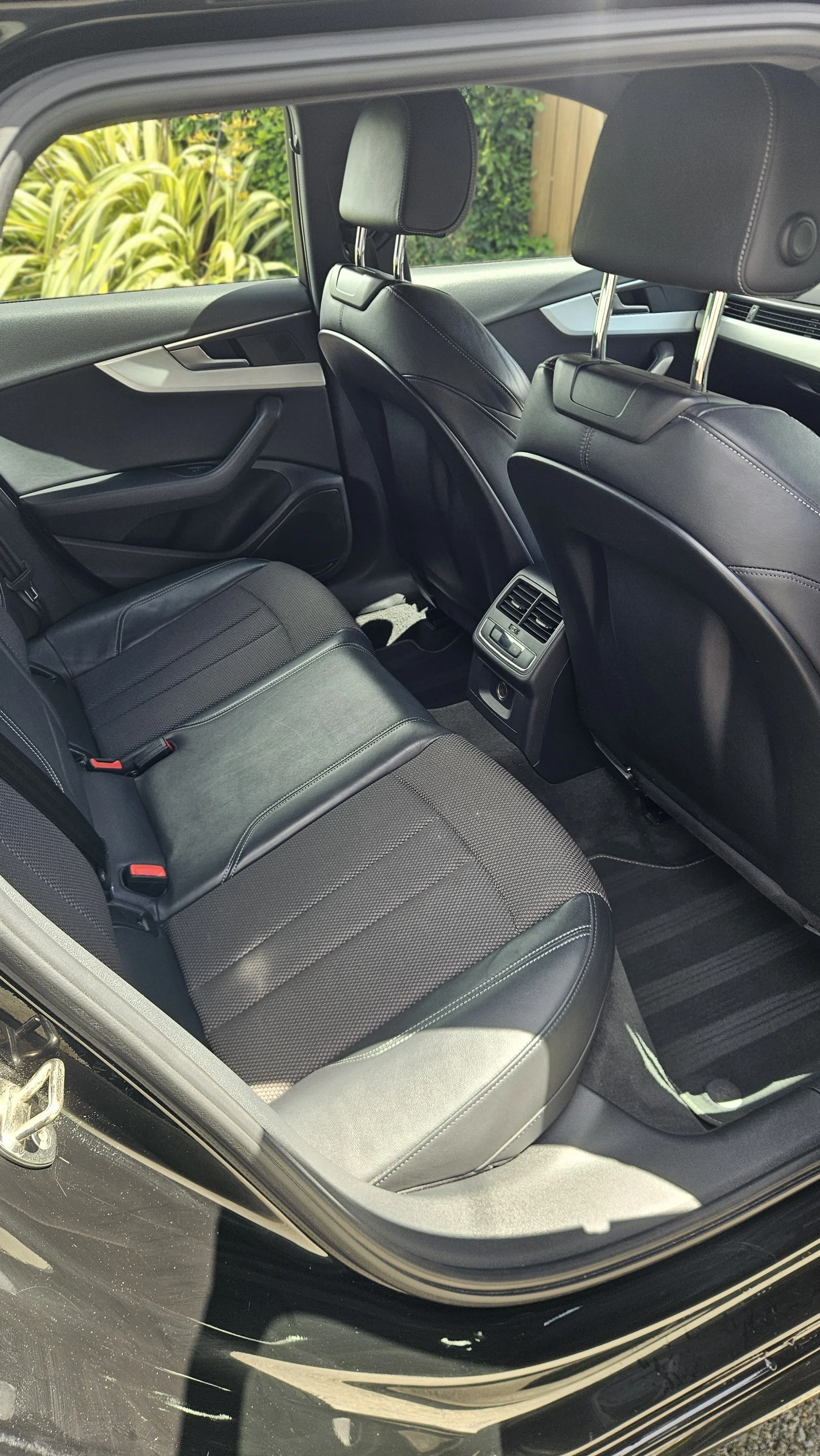 Rear seats of a B9 Audi Interior detail by North East Auto Detailing in Carlingford. The half leather seats were scrubbed to a factory finish with stain removal for the upholstery and floor mats. The door jambs were also cleaned and flushed.