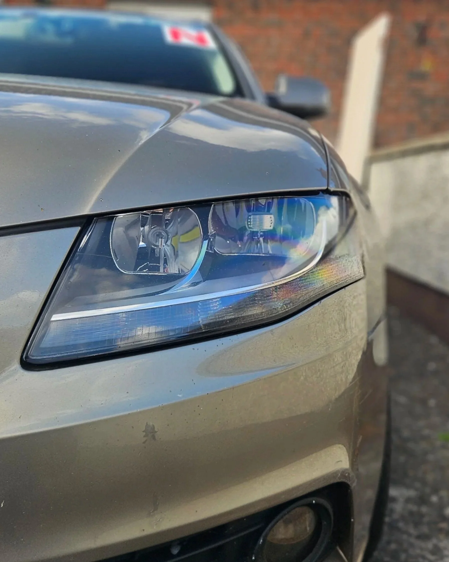 Clear, restored car headlight after ceramic coating headlight restoration by North East Auto Detailing, Dundalk