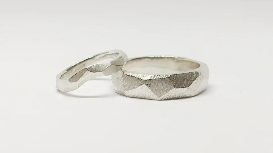 For lovers of texture and form. These bold and original wedding bands are angular, geometric and yet reminiscent of rocks. Something completely unique and meaningful to this couple
