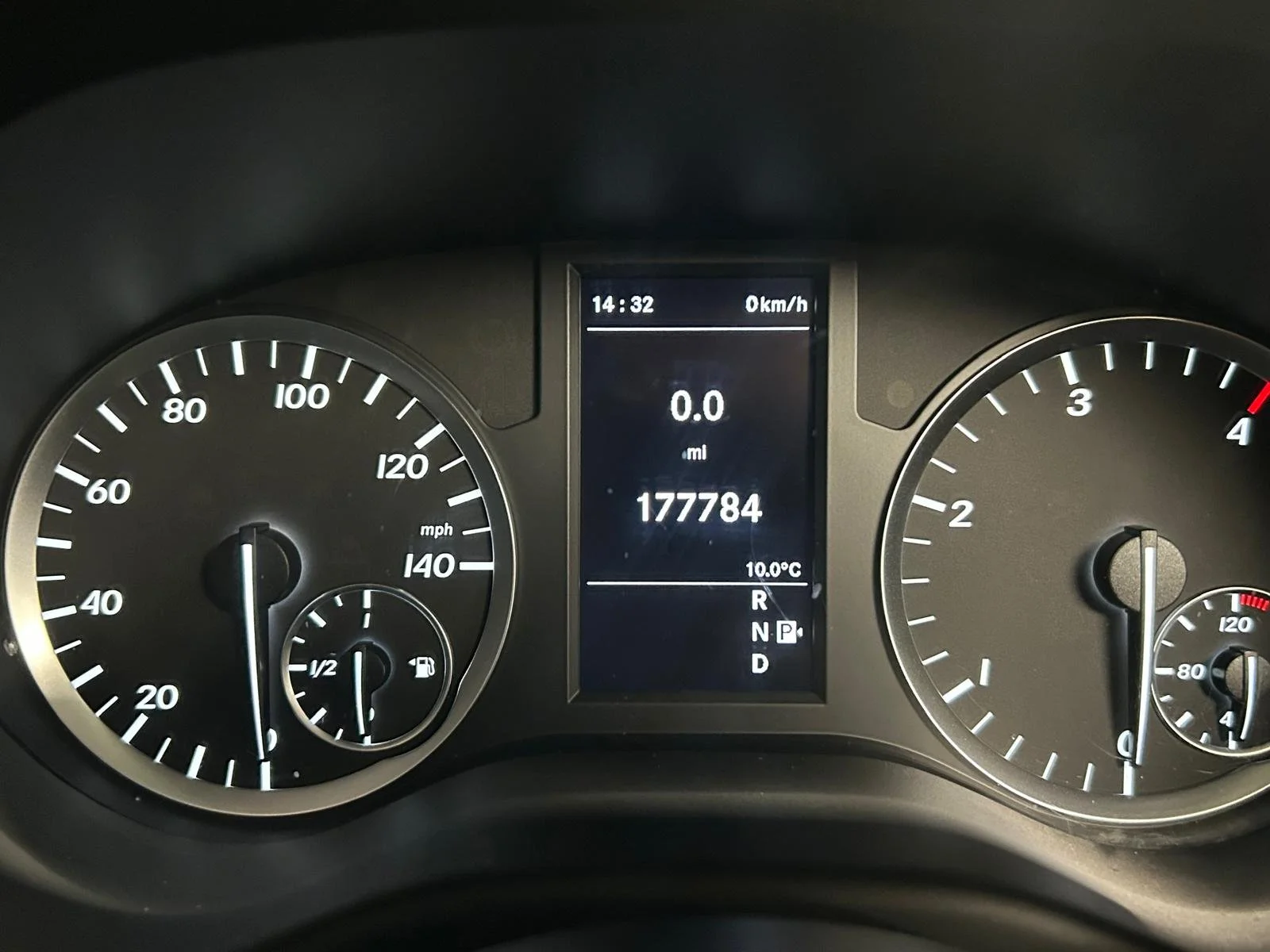 Car dashboard showing speedometer, fuel gauge, tachometer, and a digital display with odometer reading 177784 miles, current temperature 10°C, and gear position 'P'.
