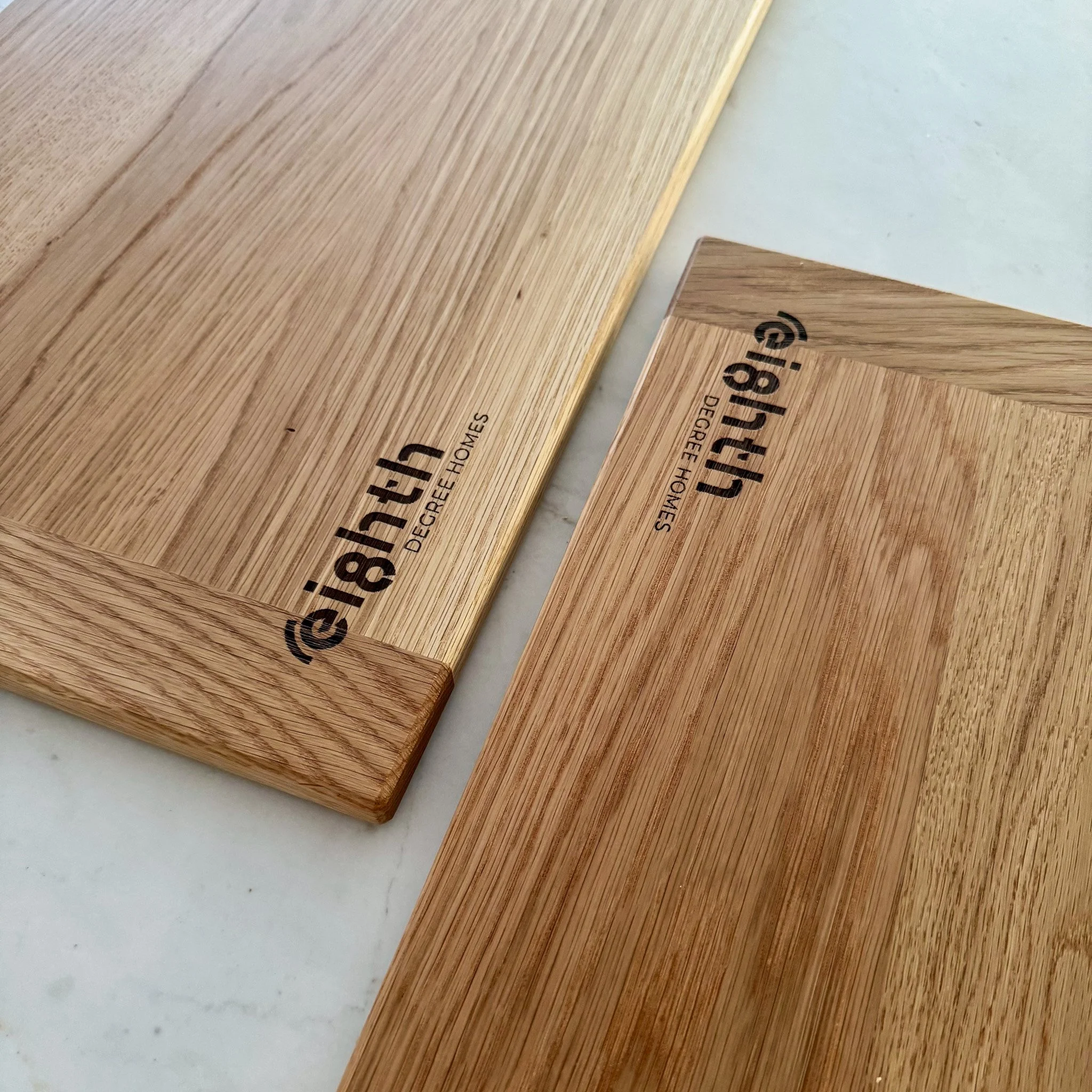 Close-up of wooden furniture with visible wood grain and partially visible text.