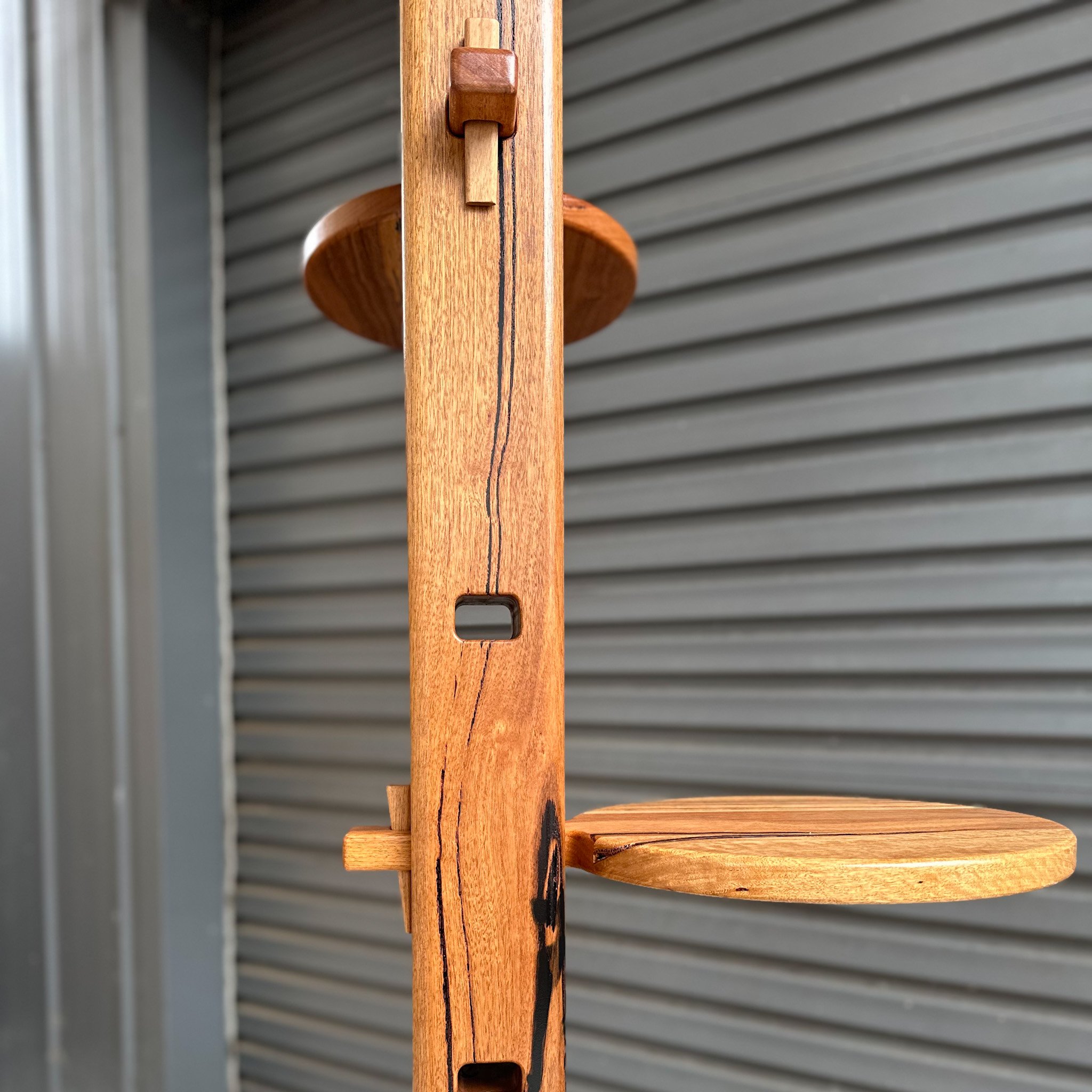 Close-up of a wooden cat climbing pole with adjustable levels using tusk and tenon joinery 