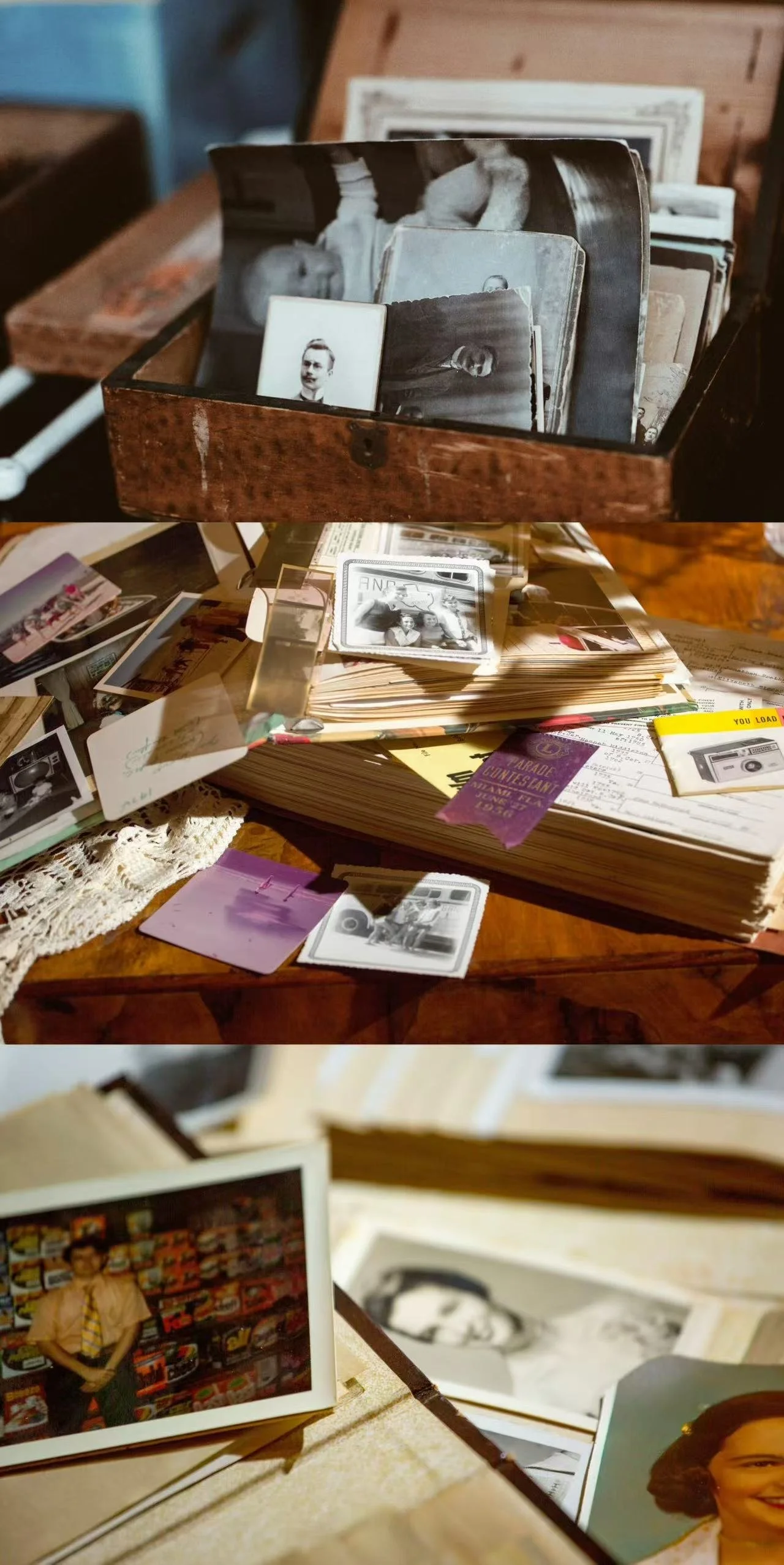 A collection of black-and-white and color photographs, vintage postcards, and handwritten notes, spread out on a wooden table and inside a wooden box.