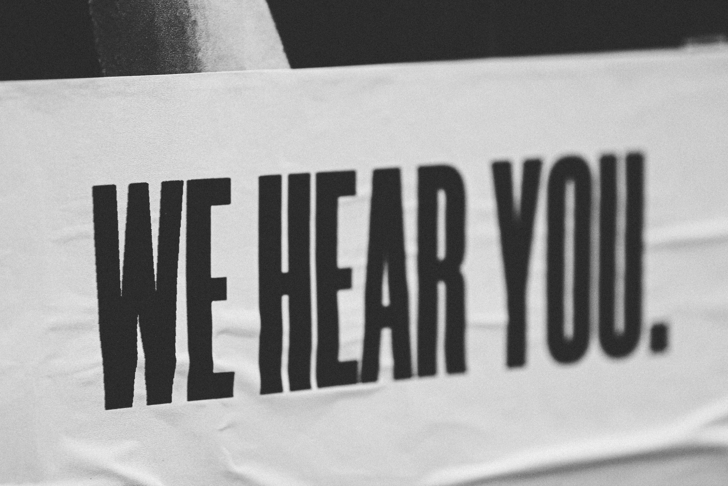 text on a banner saying we hear you.