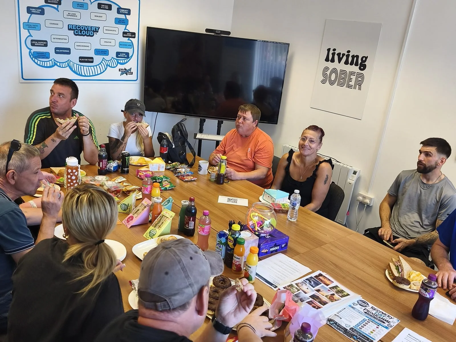 Walkers sharing lunch around the table back at Scunthorpe Recovery Service