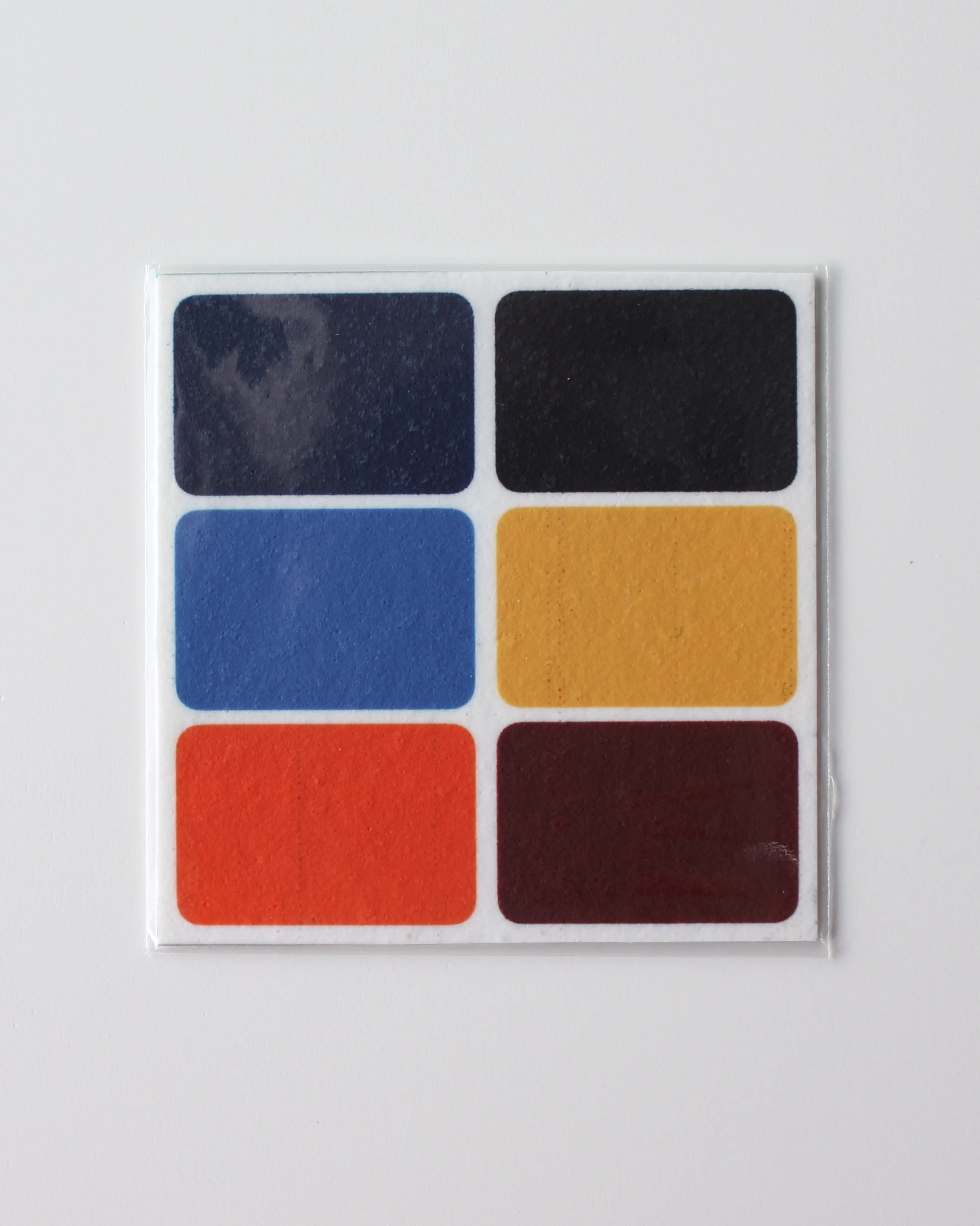 Edible paint palette featuring six food colour paints, including shades of dark blue, orange, and yellow, designed for cookie decorating.
