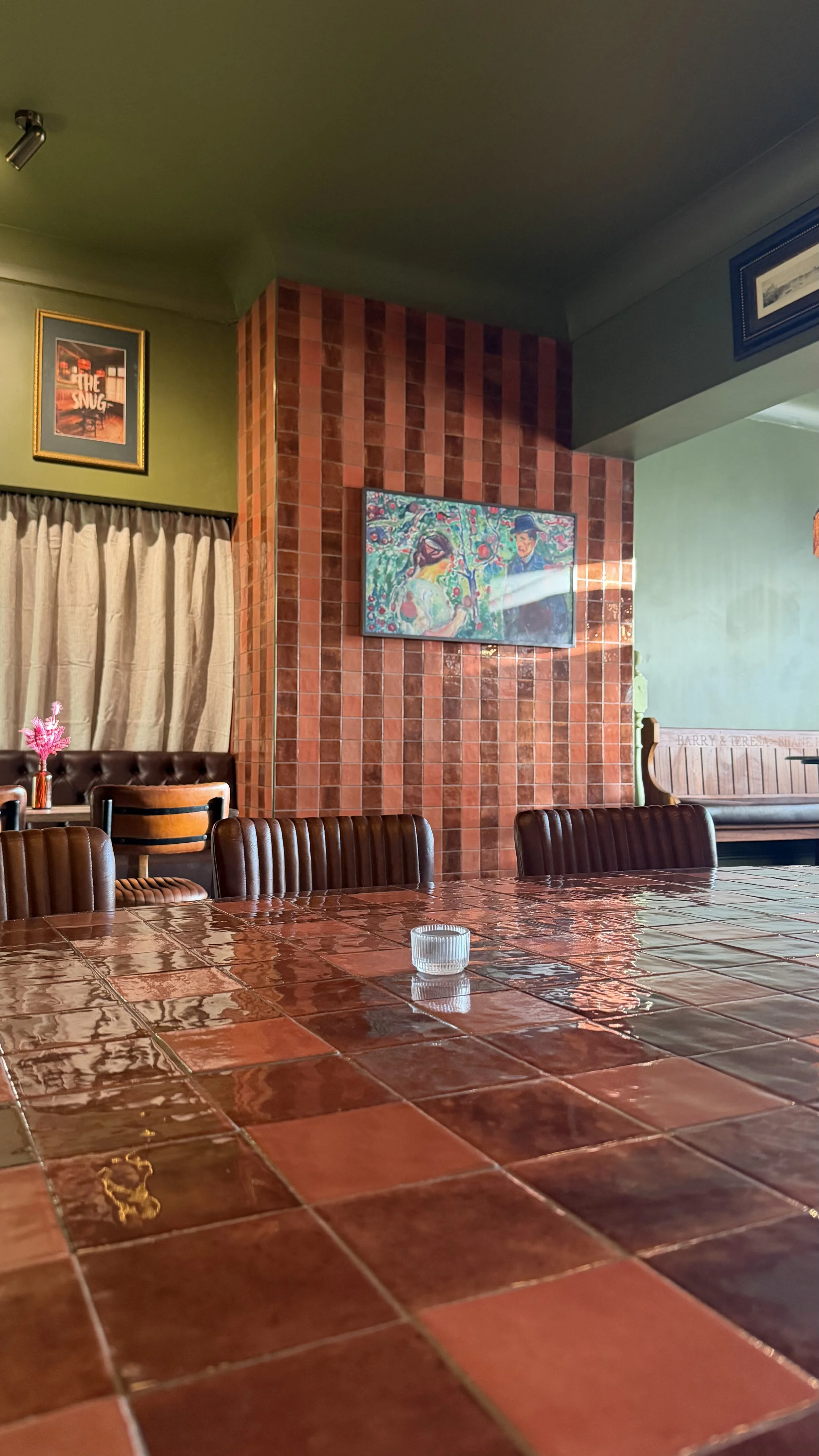 The Snug with a long table and booth seating for small parties and private dining in Bracknell