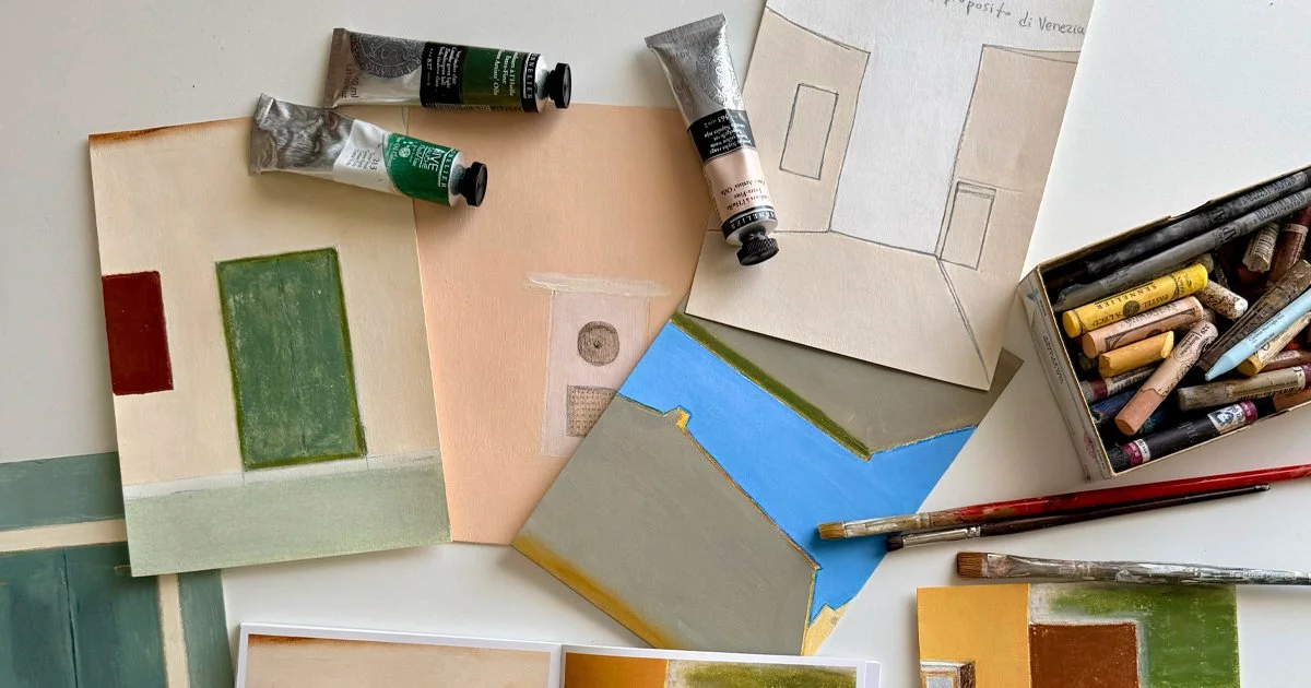 A top-down view of Aggeliki Dimitriadou's studio desk featuring the Venice artist book, oil pastels, and pencil sketches for the 'About Venice'  art book.