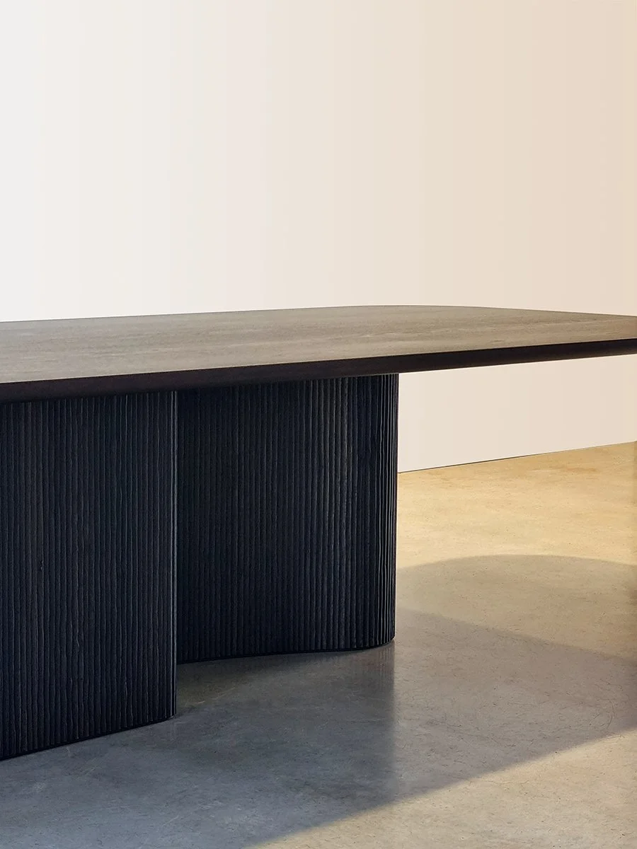 Angled side view of the Prehistoric Table in ebonised Jarrah, natural light on the tabletop - Nathan Day Design