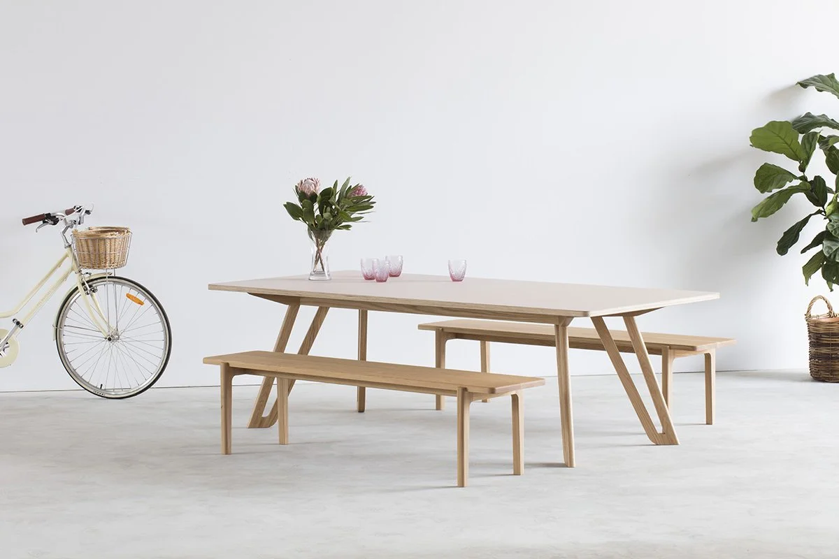 Mel Bench in American Oak, Nathan Day Design bespoke furniture - lifestyle setting with matching table and bicycle