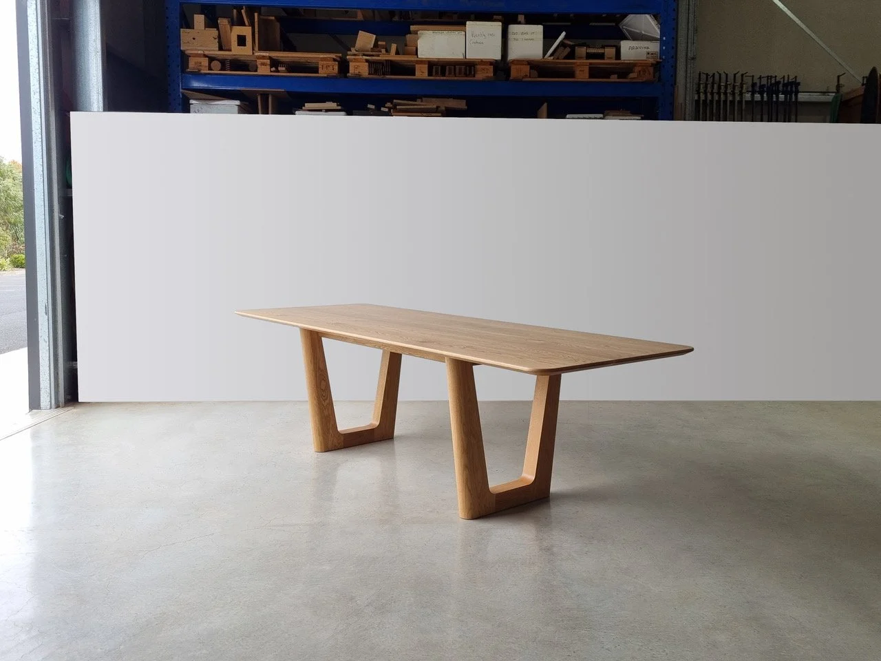 Aalia Table in solid American Oak with angled V-shaped leg base, designed for Aalia Restaurant Sydney, workshop setting - bespoke furniture by Nathan Day Design