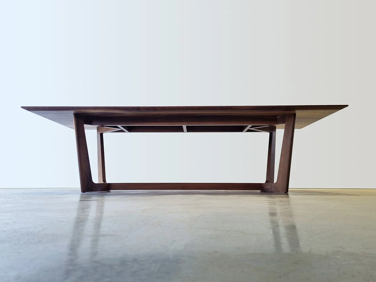 Low wooden coffee table with angular legs, handcrafted by Nathan Day Design.