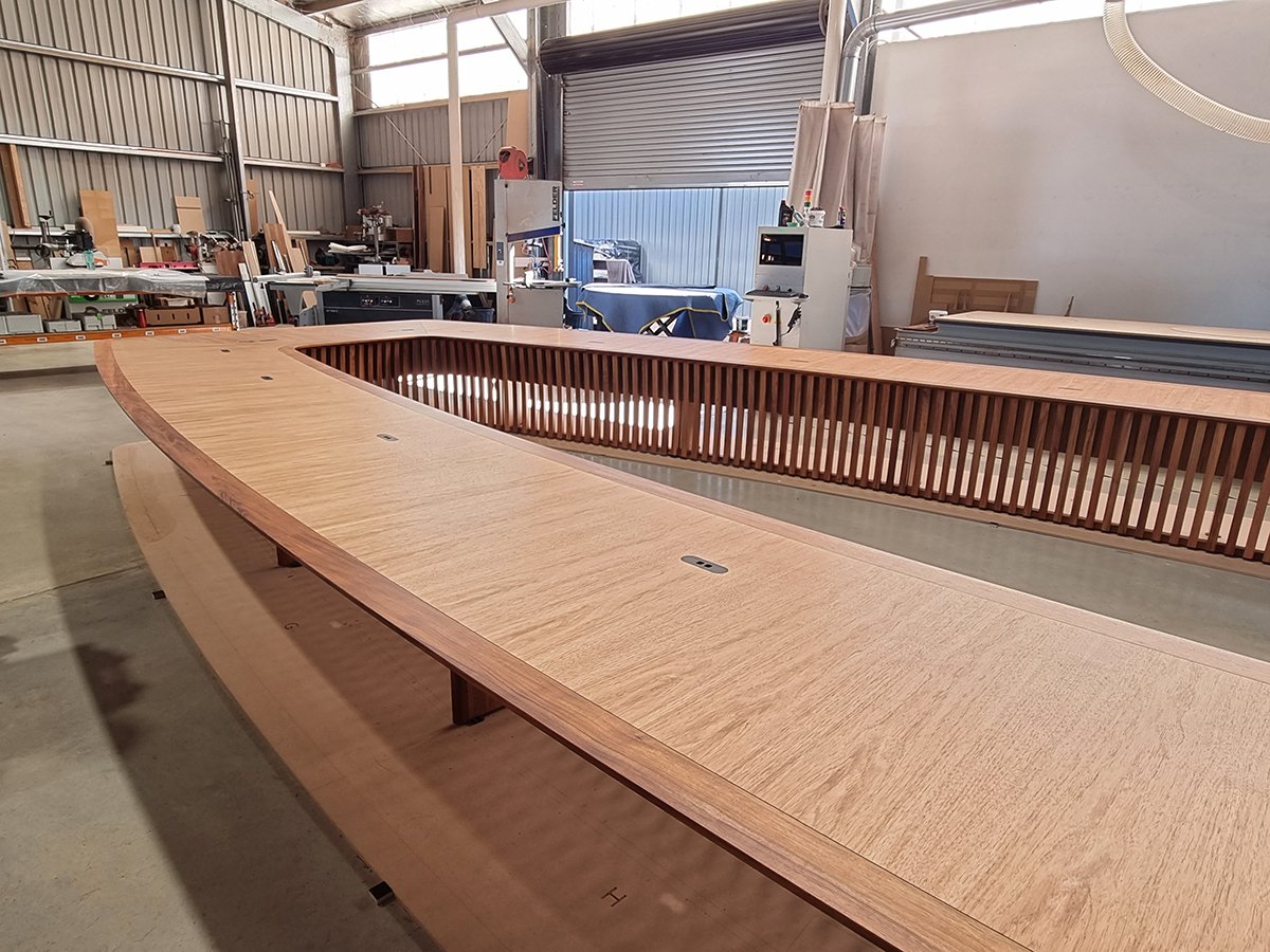 One - The Esplanade Boardroom Table in Australian Blackwood, fluted leg design - Nathan Day Design, long side view of table under construction in workshop