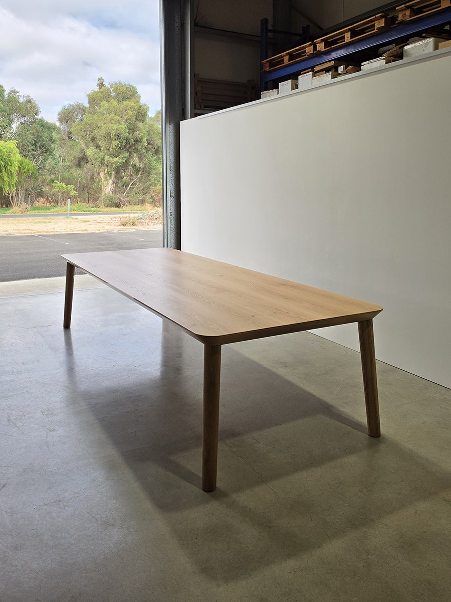 Mercator Way Table in American Oak, minimalist torsion box design in the workshop doorway - bespoke furniture by Nathan Day Design