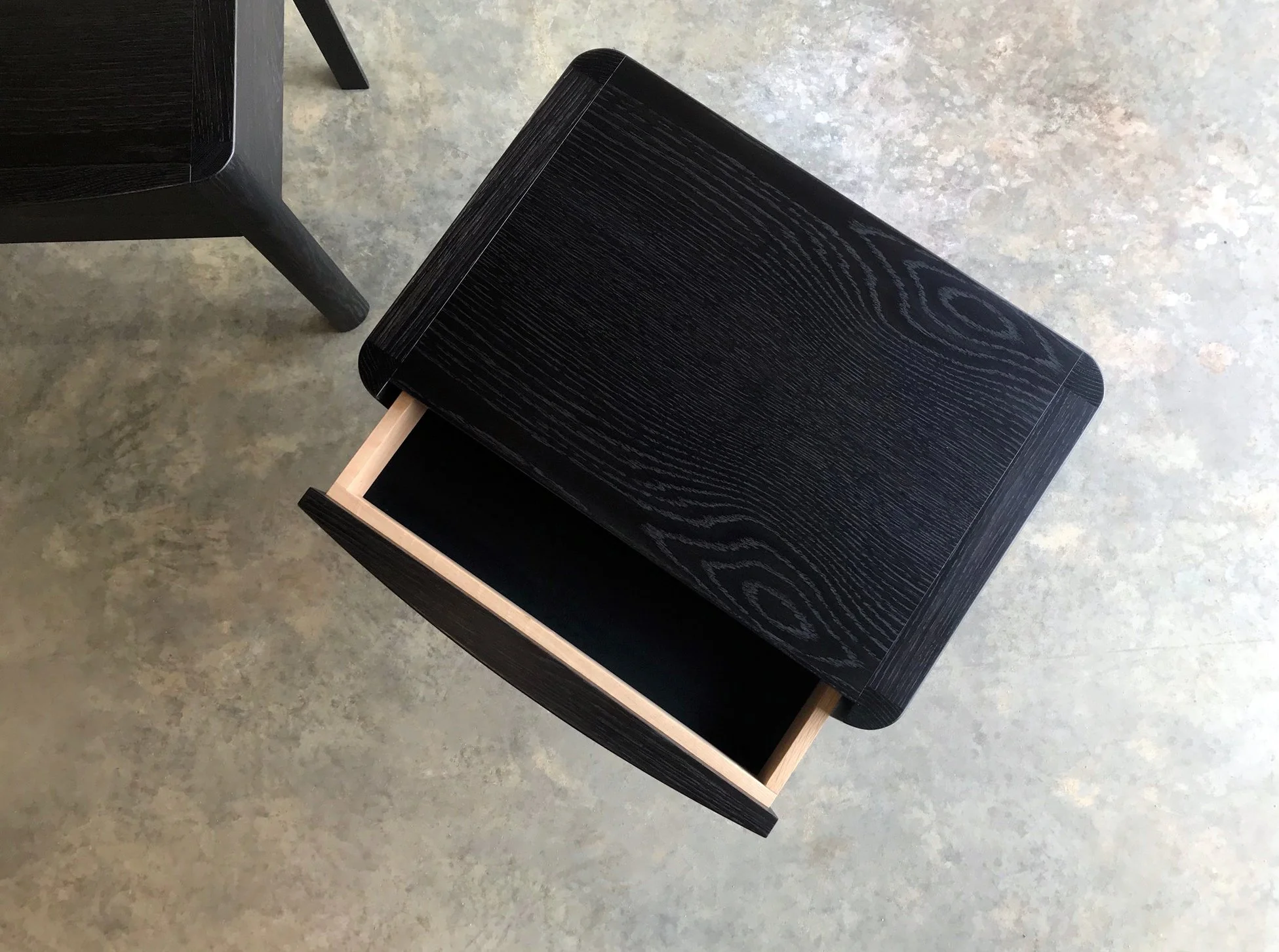Hampden Bedside Table in Oak - Nathan Day Design, ebonised black finish variant with drawer open, angled shot