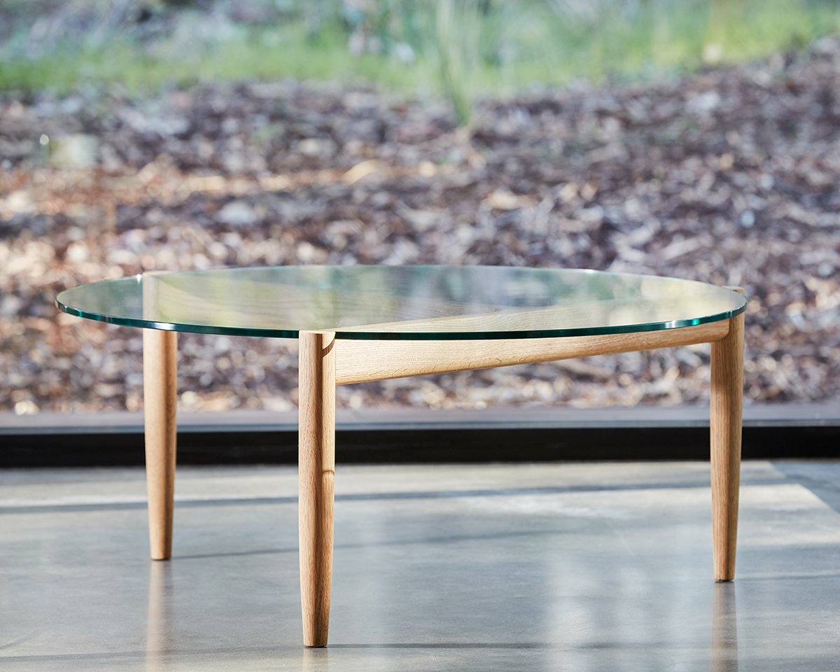 3.2.1 Coffee Table in American Oak with glass top, set against a native garden backdrop - Nathan Day Design