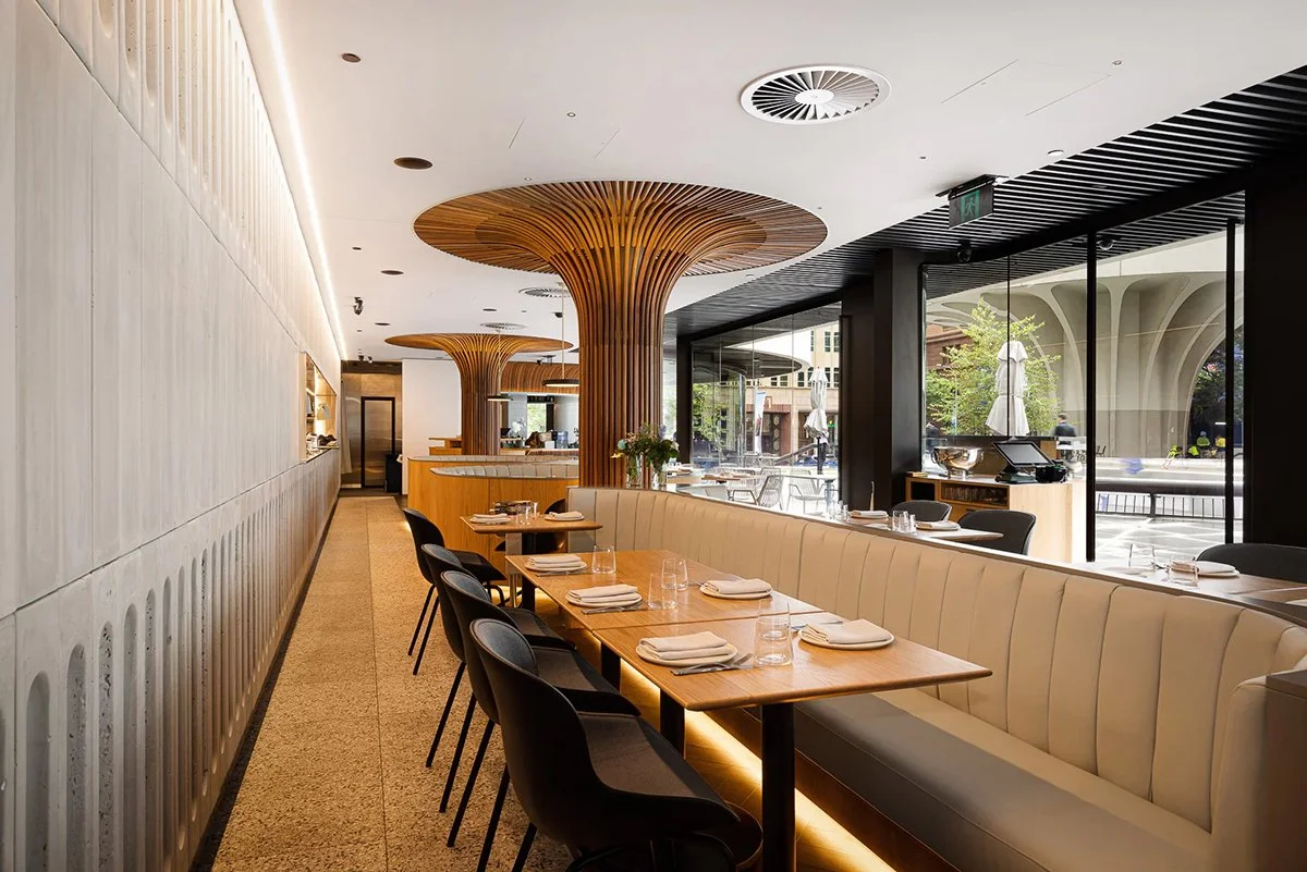 Aalia Restaurant Sydney booth seating with custom Oak tables beneath a sculptural tree-form timber ceiling and street view - Nathan Day Design