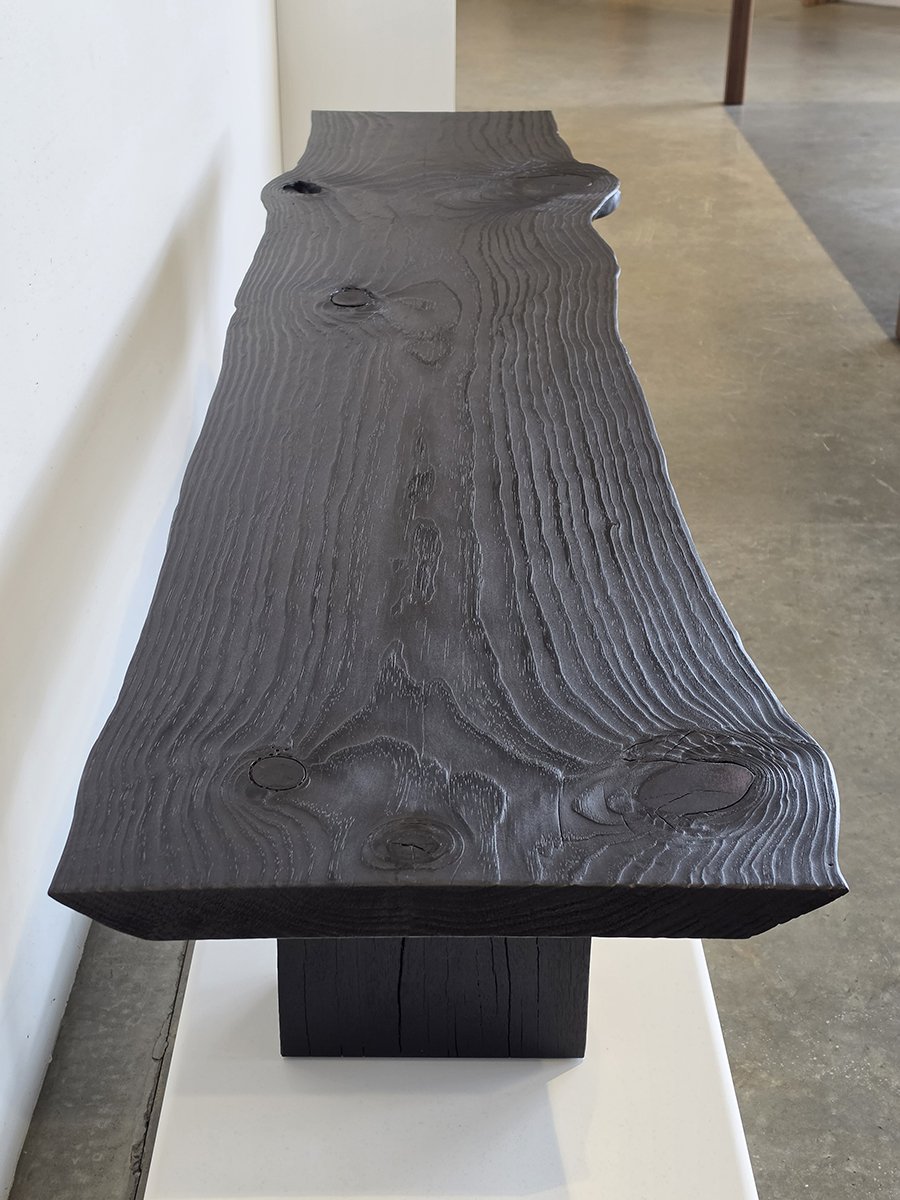 Overhead view of Burnside Bench showing dramatic scorched wood grain texture with prominent natural knots along the slab surface - bespoke seating by Nathan Day Design