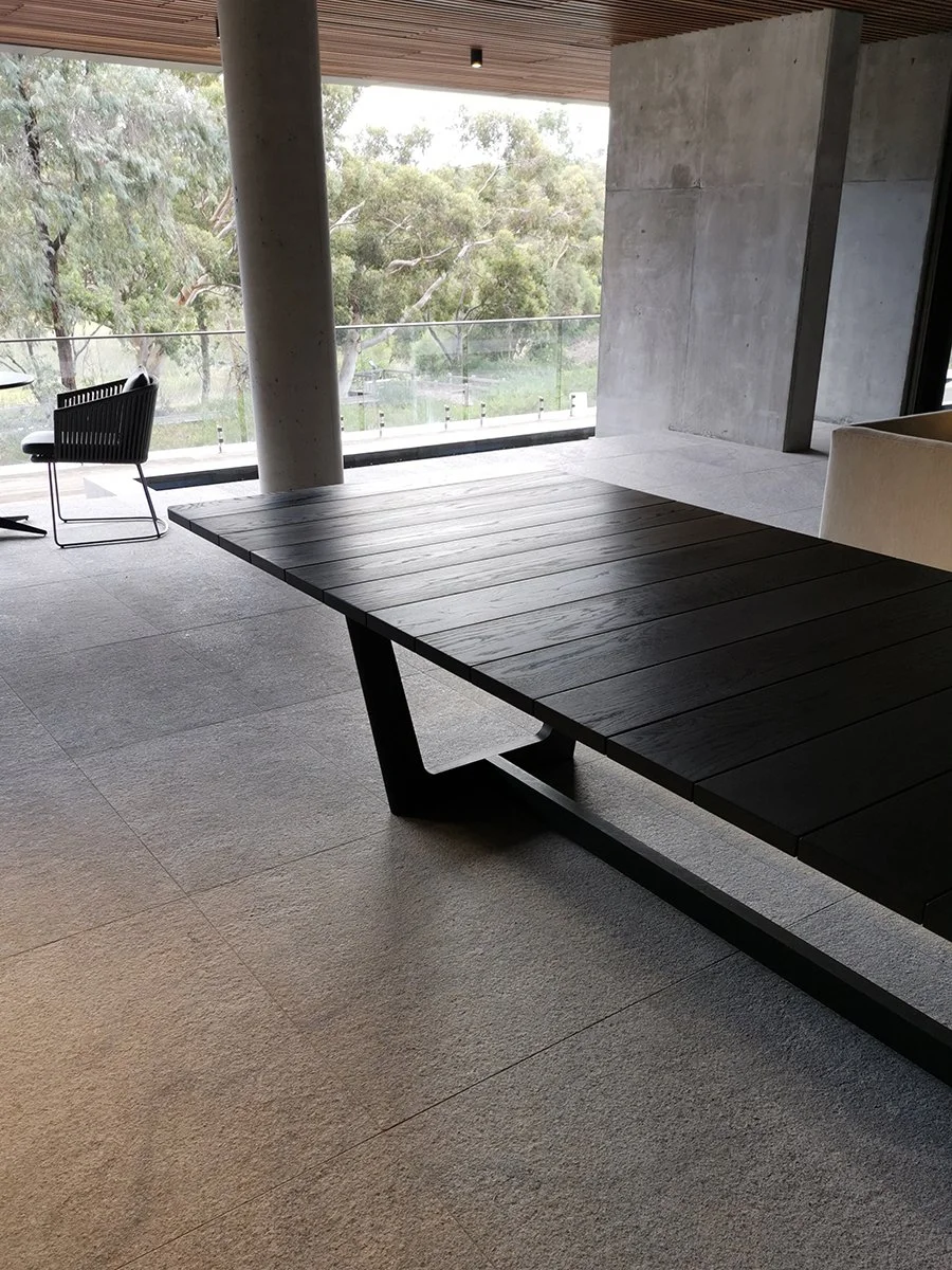 Eden Outdoor Table in ebonised timber - Nathan Day Design, close-up of V-leg base meeting the floor