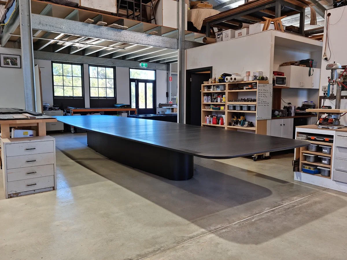 Walters Drive Boardroom Table in ebonised Walnut - Nathan Day Design, end-on view of completed table in workshop