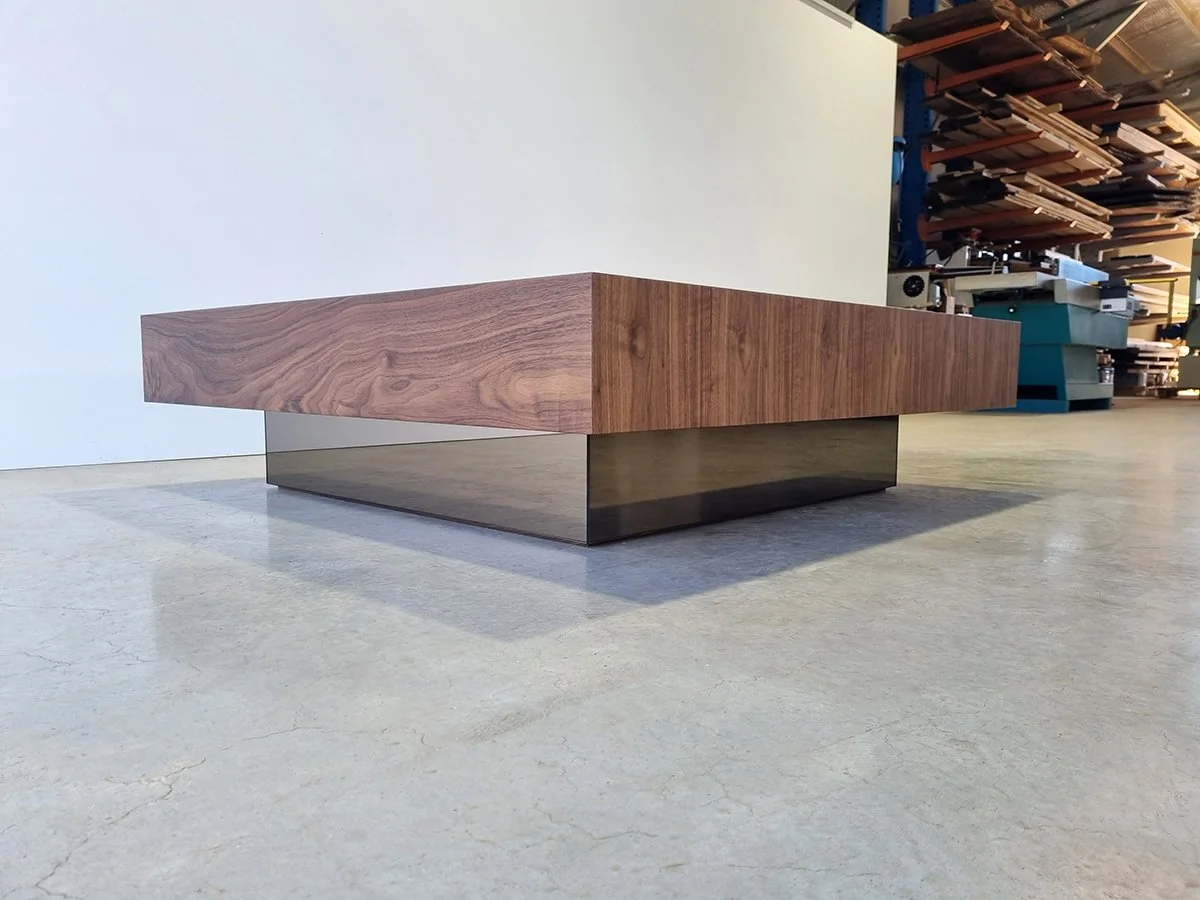 Angled workshop view of the Parker St Coffee Table showing the reflective bronze mirror base - Nathan Day Design