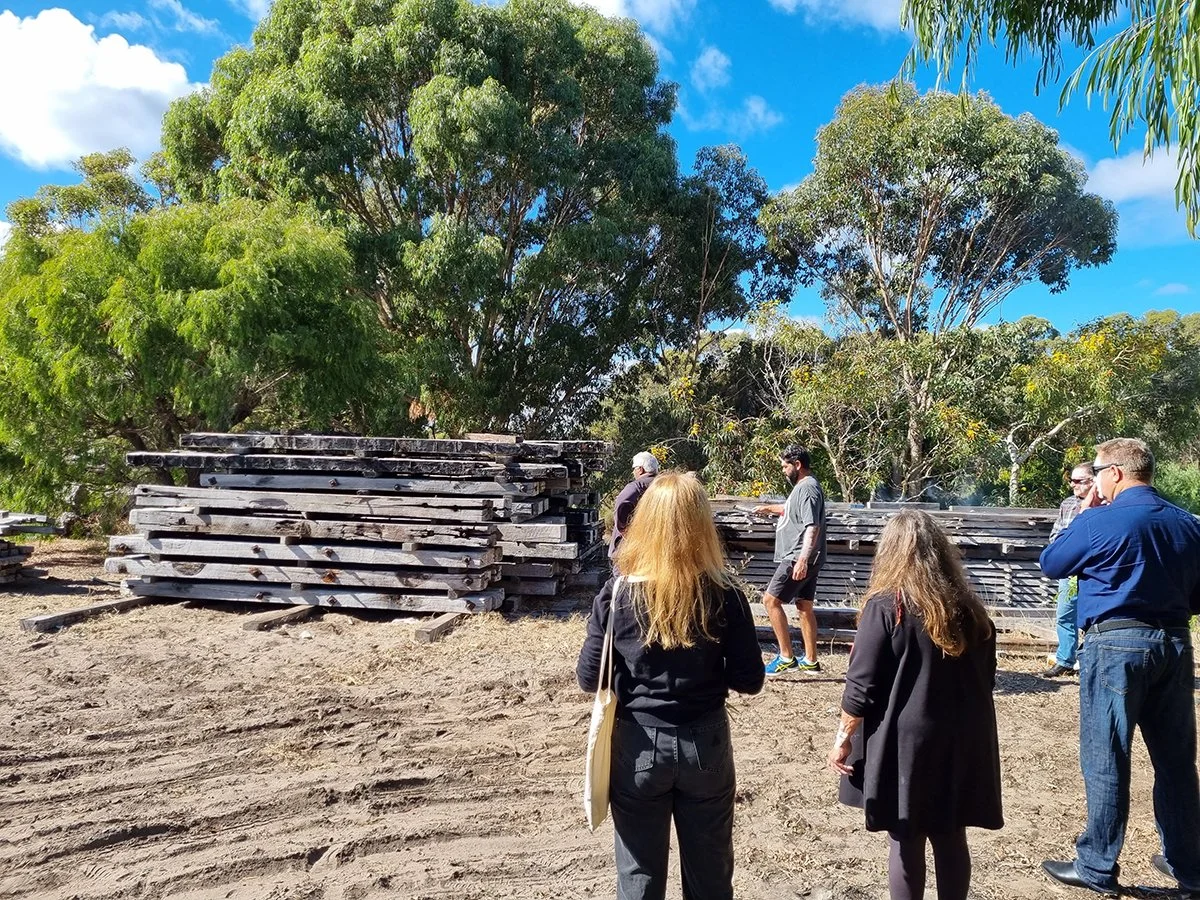 Reception Counter - One The Esplanade in scorched timber - Nathan Day Design, team inspecting stack of raw sleeper timber for material selection