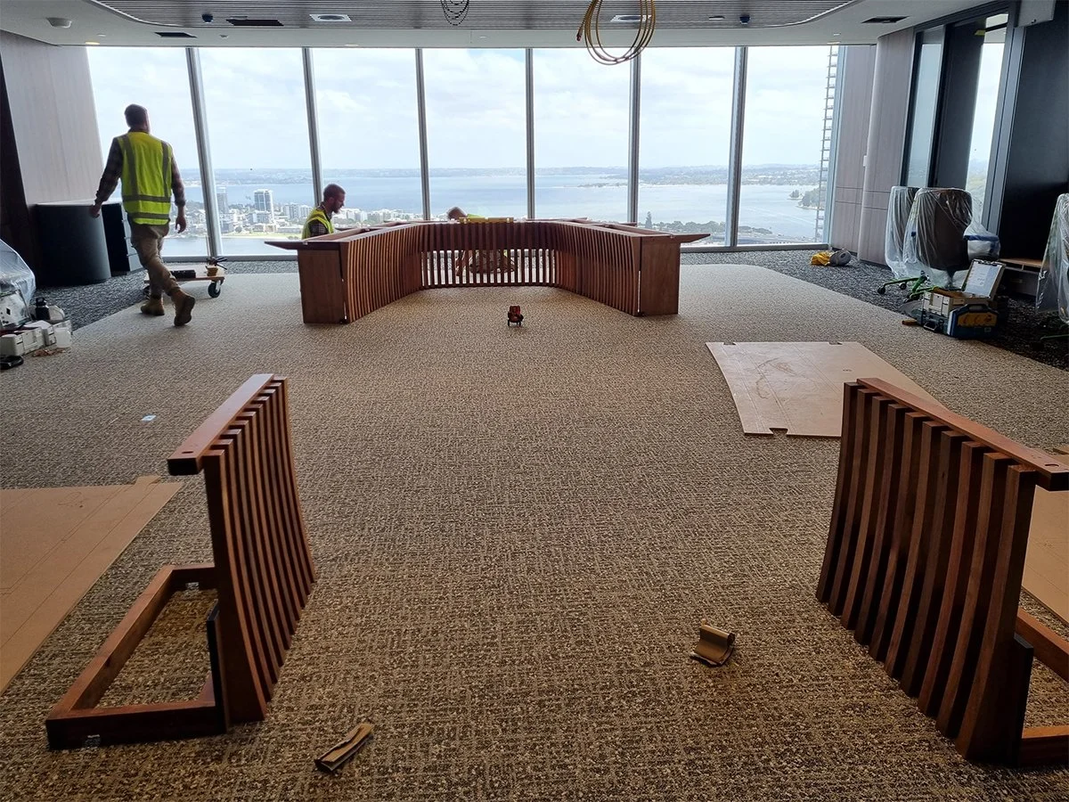 One - The Esplanade Boardroom Table in Australian Blackwood, fluted leg design - Nathan Day Design, on-site installation in empty office space
