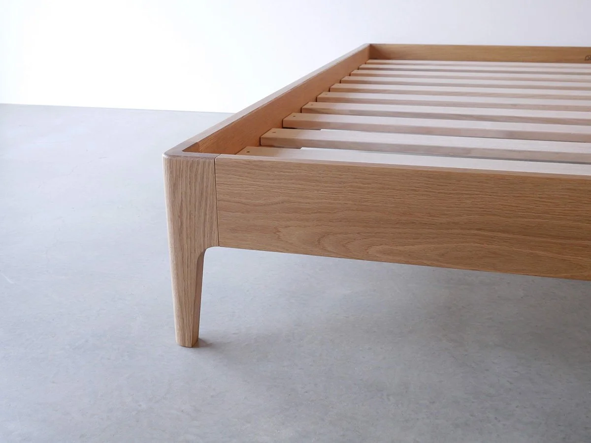 Quindalup Bed in American Oak - Nathan Day Design, close-up of tapered leg and slat base joinery