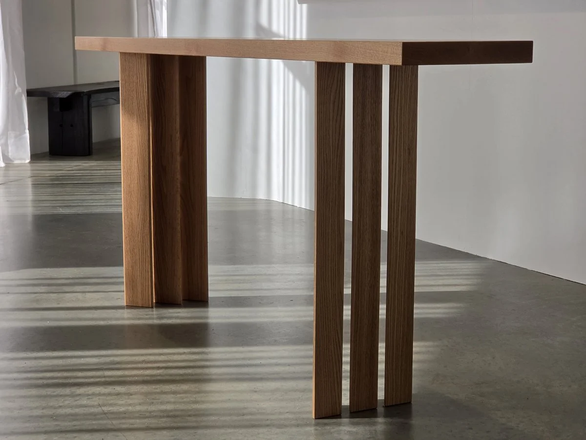 Prism Console in Red Oak, full front-angled view showing tripod leg arrangement - Nathan Day Design