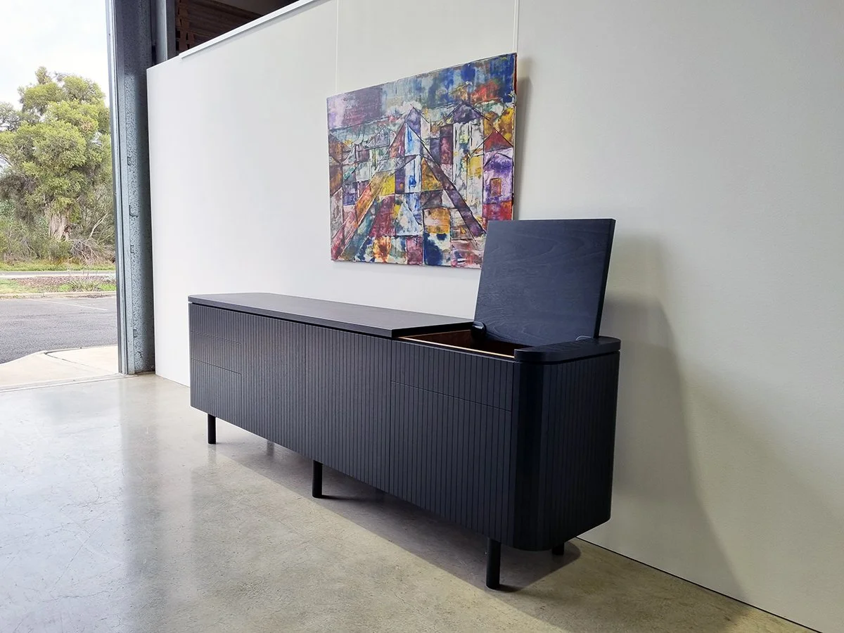 Freeman Loop Credenza in ebonised Walnut, installed with colourful artwork on wall, hinged top open - Nathan Day Design