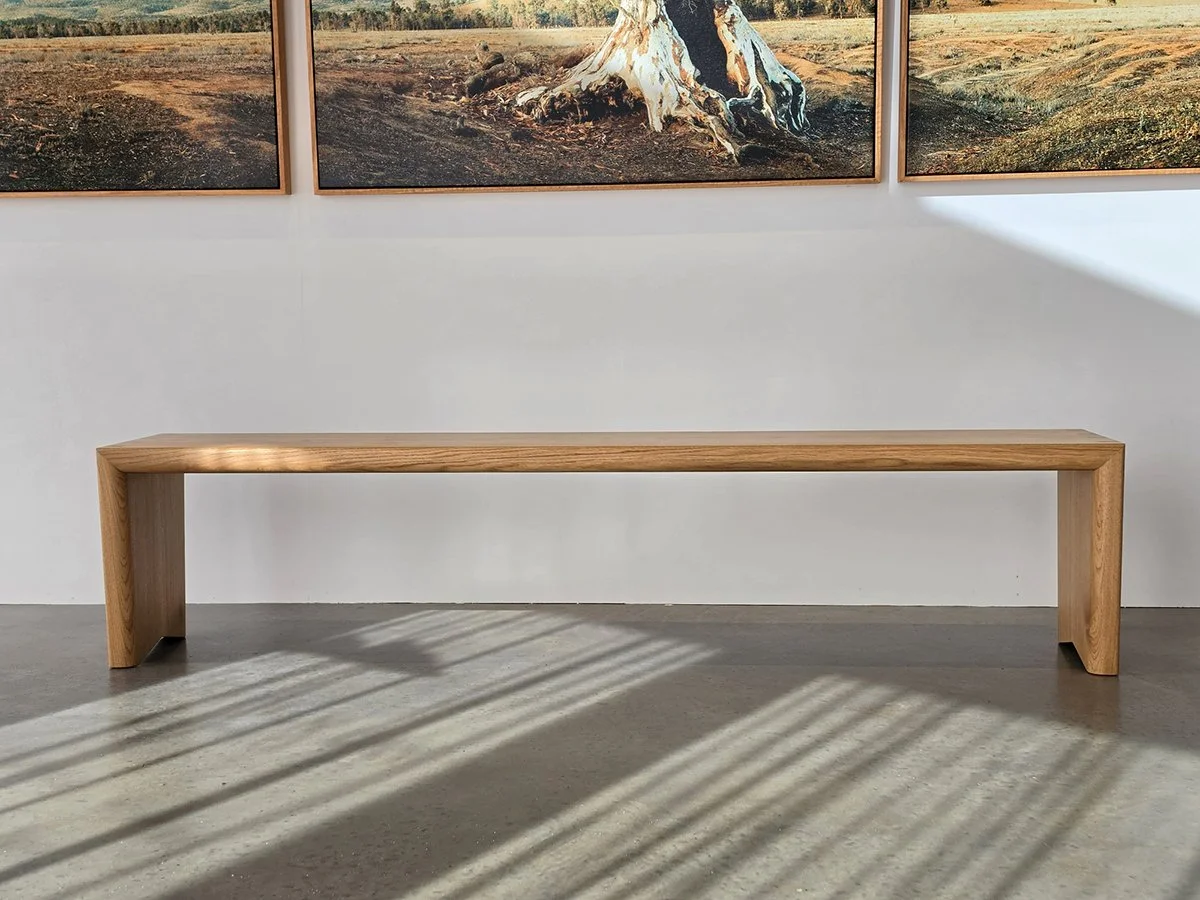 Dovetail Bench in American Oak with exposed dovetail joinery, Nathan Day Design - gallery interior with landscape artwork