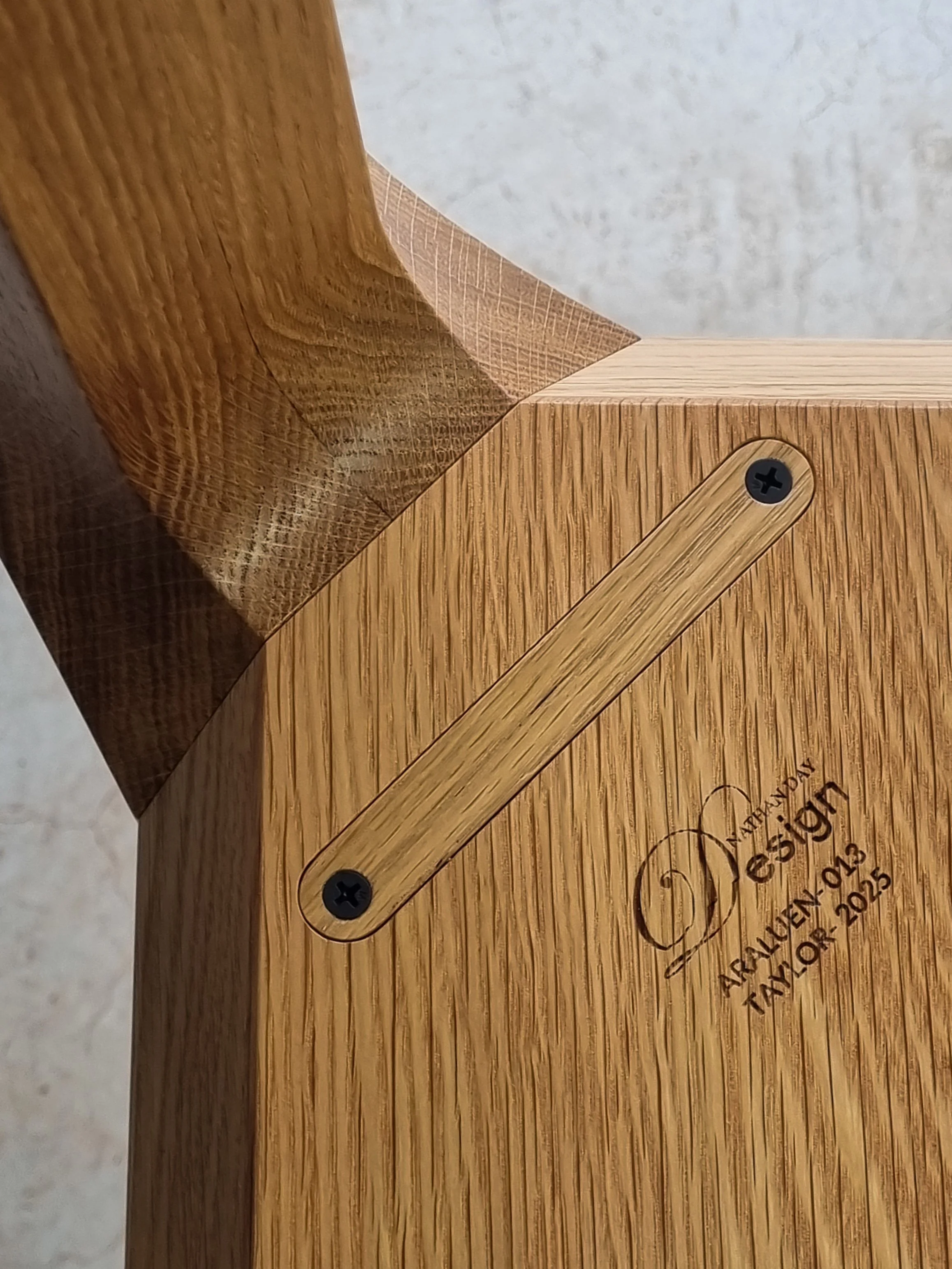 Detail of the Araluen Table's underside joinery and branded Nathan Day Design maker's plaque