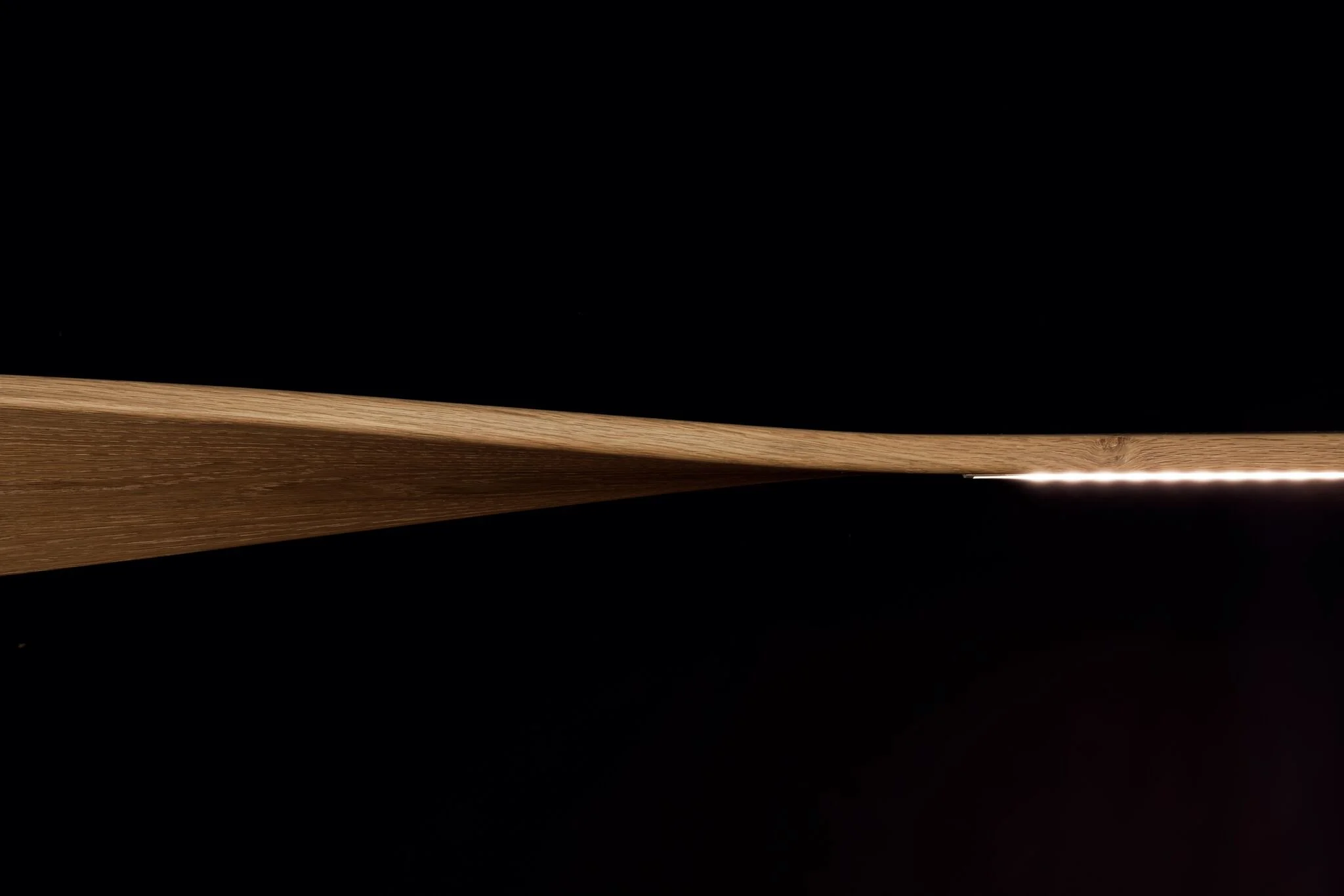 Ernest Pendant Light in Ash, elongated blade-form design - Nathan Day Design, close-up detail of leading edge with lit LED strip