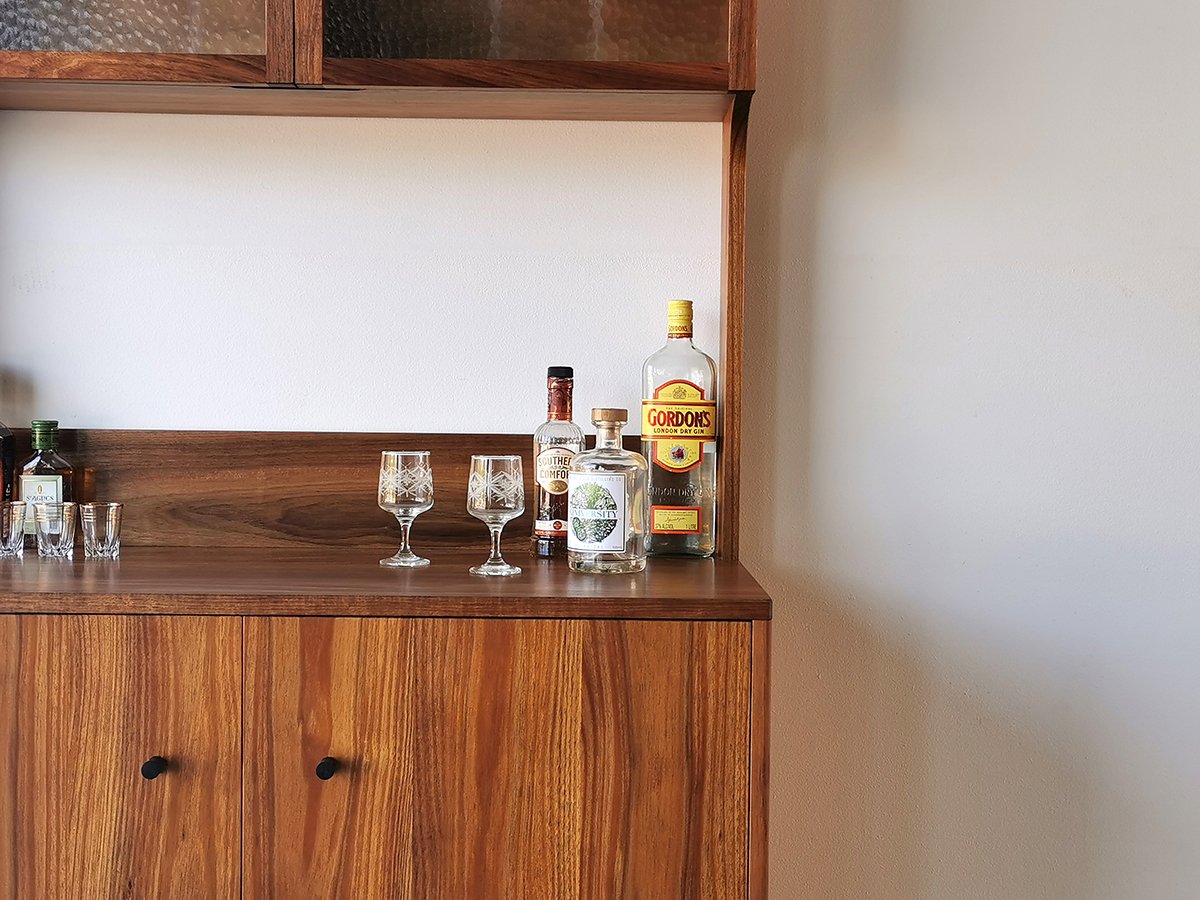 Jarvis Drinks Cabinet in Tasmanian Blackwood, close-up of open top shelving with glassware and spirits - Nathan Day Design