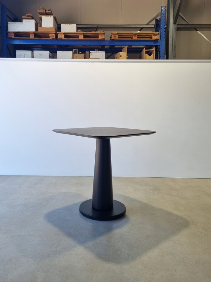 Majestic Cellar Table in ebonised Jarrah, tapered trumpet-leg pedestal design, workshop setting - Nathan Day Design