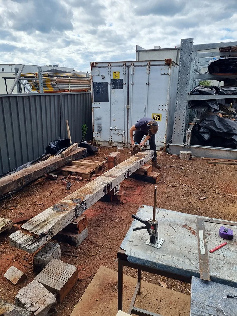 Reception Counter - One The Esplanade in scorched timber - Nathan Day Design, timber milling in progress at outdoor site setup