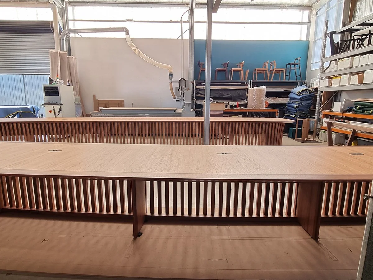One - The Esplanade Boardroom Table in Australian Blackwood, fluted leg design - Nathan Day Design, side view of finished slatted apron table in workshop