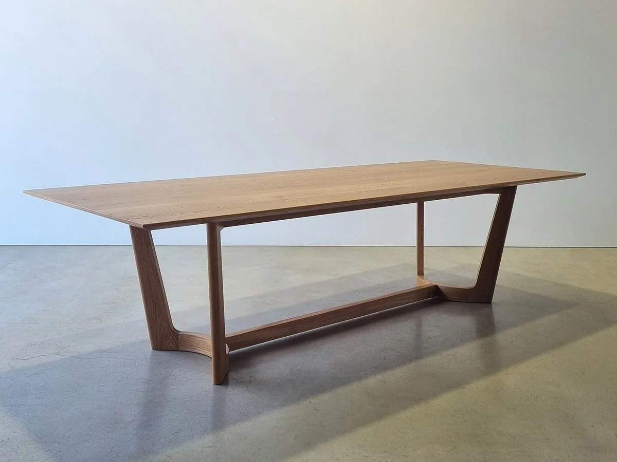 Froxfield Table in Walnut, refectory-style base with curved rails and tapered legs - bespoke furniture by Nathan Day Design