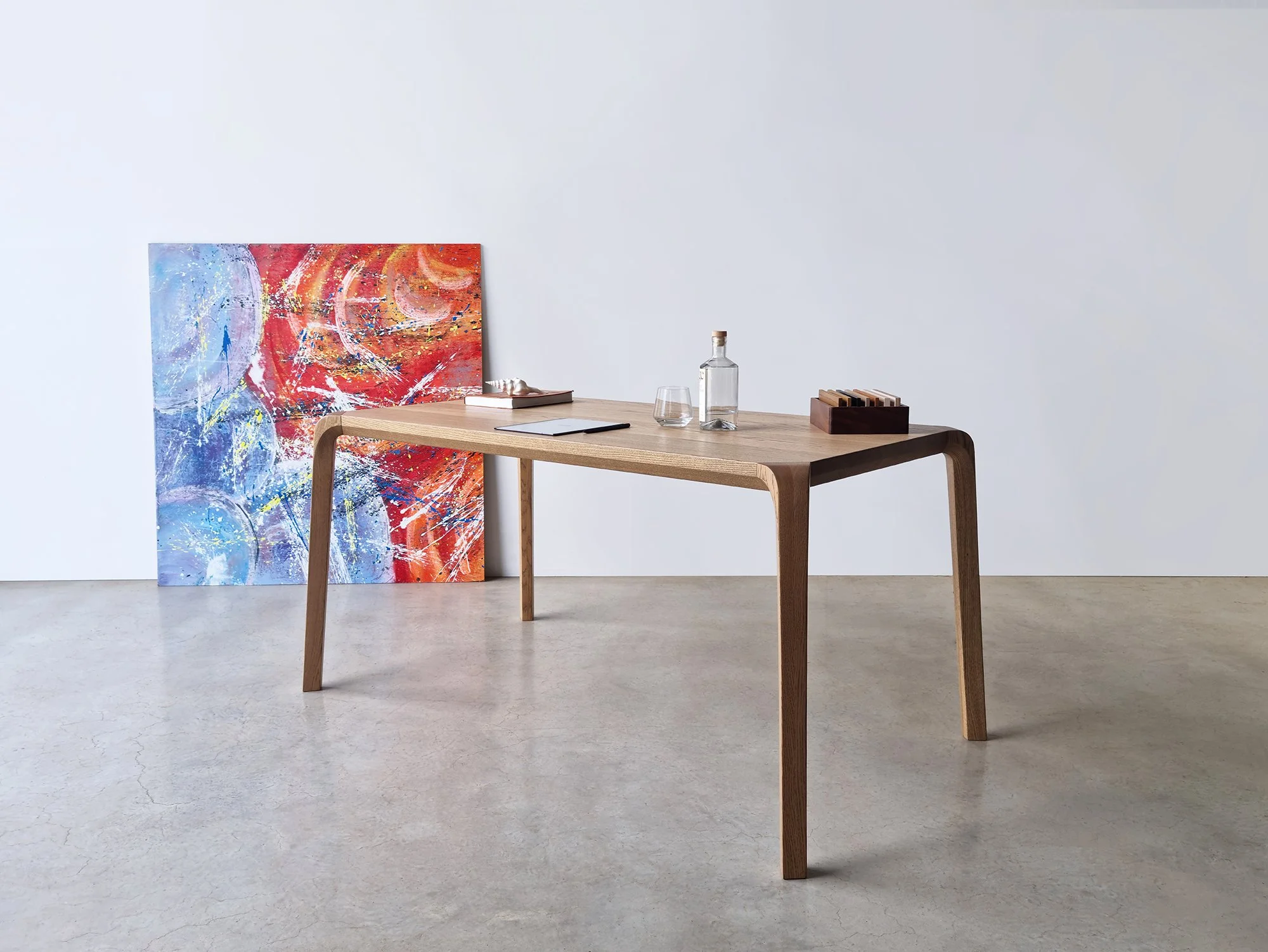 Araluen Desk in American and French Oak, full front view with artwork backdrop in studio - Nathan Day Design
