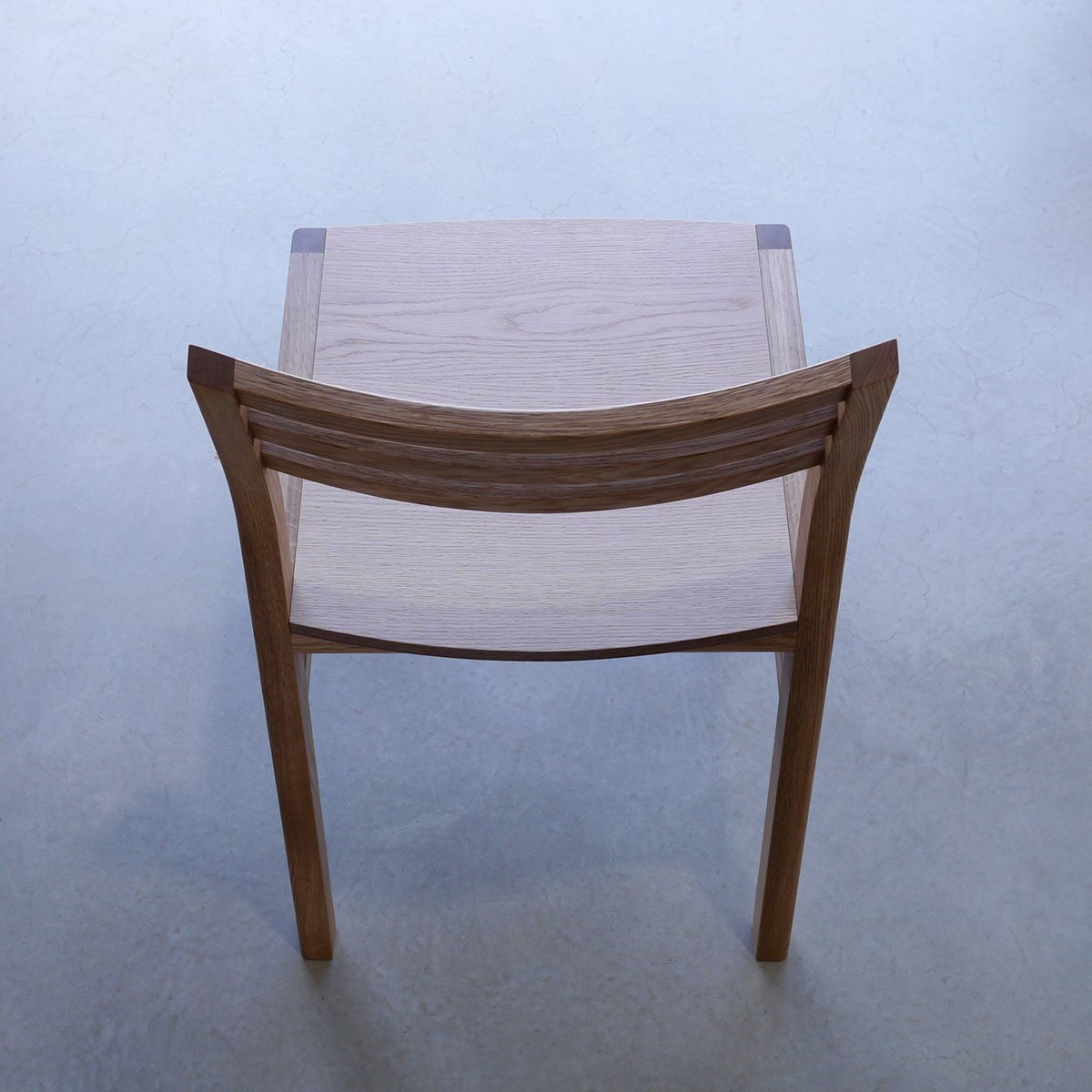 Rear elevated view of Walter Dining Chair in Walnut showing the seat surface and curved backrest slats - bespoke furniture by Nathan Day Design